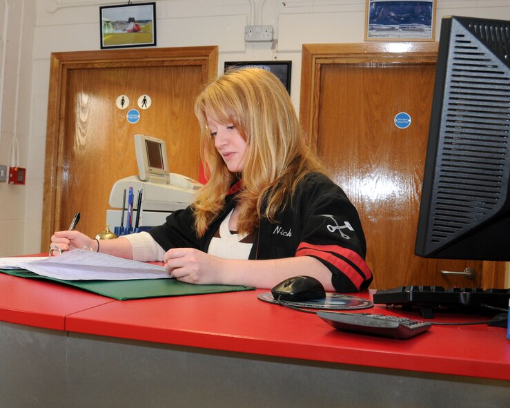 Ashlee Lhamon, 100th Force Support Squadron procurement clerk from Waynesville, Ohio, checks the auto hobby complex appointment book Jan. 9, 2013, at RAF Mildenhall, England. The complex offers space and equipment for U.S. base ID card holders and their dependants to perform do-it-yourself repairs and maintenance. (U.S. Air Force photo by Gina Randall/Released)