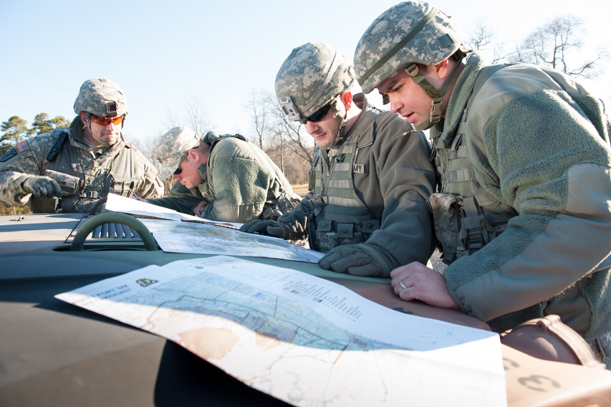 Soldiers from the 382nd Military Police Battalion, look over area maps in preparation for the combat support training exercise Dec. 13, 2012, on Joint Base McGuire-Dix-Lakehurst, N.J. Army units conducted the site surveys to get a feel for the training location during the 78th Training Division’s Joint Planning Conference. The sites will be used for instruction on observation, fields of fire, identifying obstacles and avenues of approach in the battlefield. (U.S. Air Force photo by Russ Meseroll/Released)