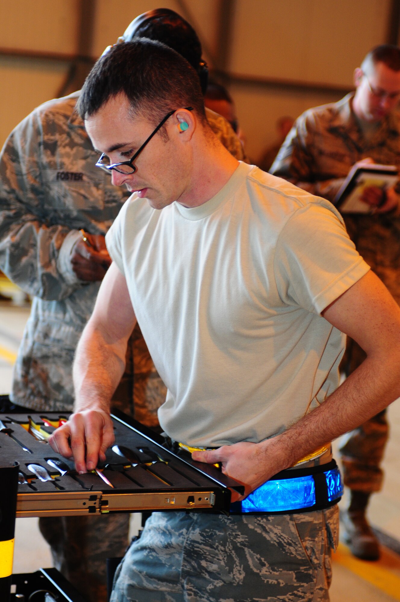 ROYAL AIR FORCE LAKENHEATH, England -- Senior Airman Jared Gregory, 493rd Aircraft Maintenance Unit weapons load crew member, puts away tools after loading munitions onto an F-15C Eagle during the quarterly load crew competition Jan. 7, 2013. The winner is determined by the fastest time loading munitions with the least amount of errors. (U.S. Air Force photo by Airman 1st Class Dana J. Butler)

