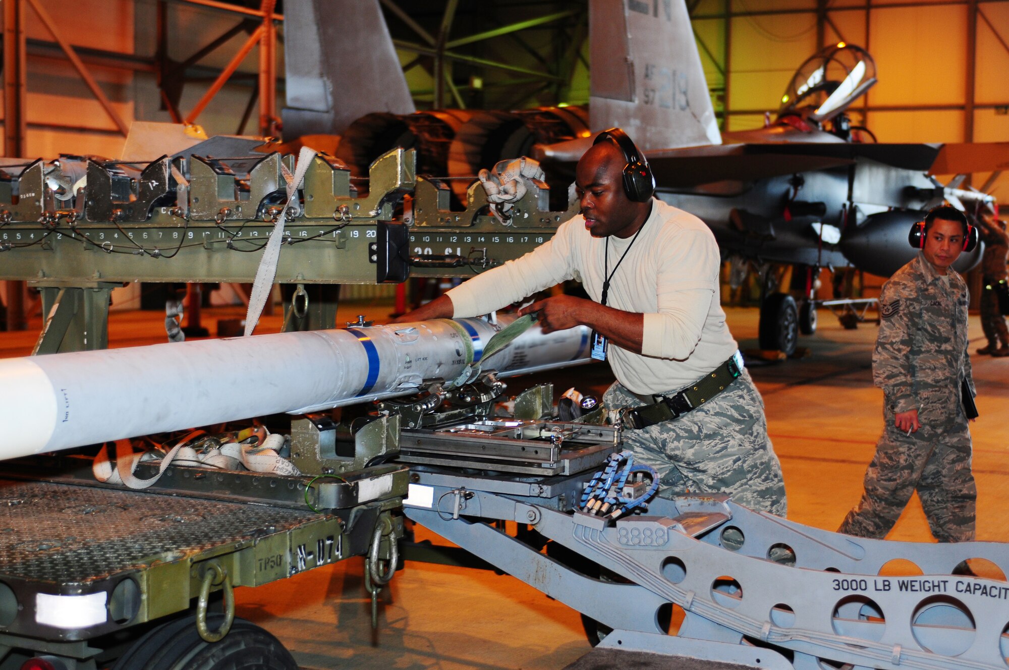 ROYAL AIR FORCE LAKENHEATH, England - Tech. Sgt. Thomas Williams, 494th Aircraft Maintenance Unit weapons load crew team chief, prepares to transport an AIM-120 munition to load onto an F-15E Strike Eagle during the quarterly load crew competition Jan. 7, 2013. The winner is determined by the fastest time loading munitions with the least amount of errors. (U.S. Air Force photo by Airman 1st Class Dana J. Butler) 

