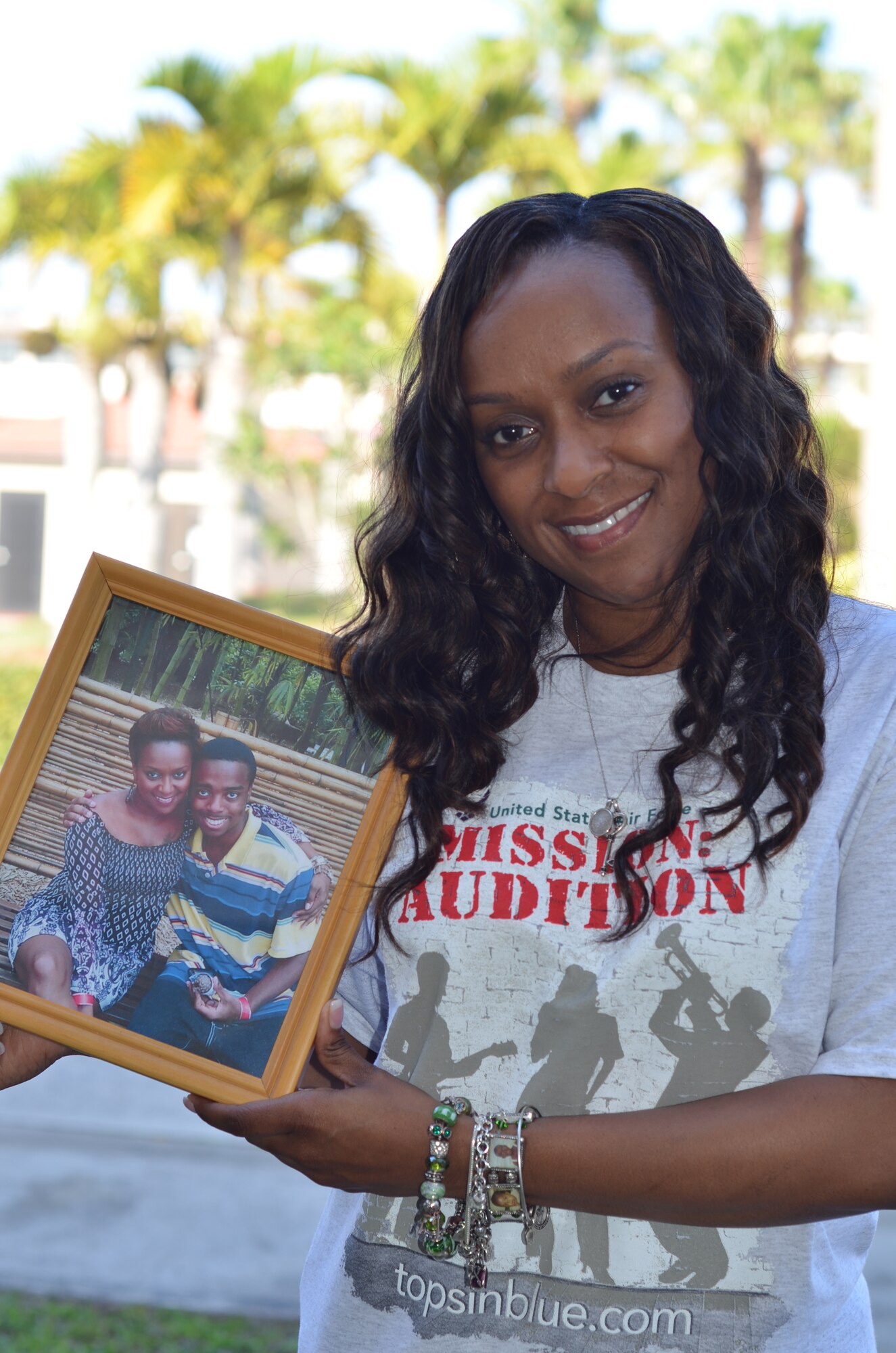 Air Force Reservist, Tech. Sgt. Altrameise Myers, information management craftsman, 920th Rescue Wing, Patrick Air Force Base, Fla., poses with a photo of her late son AJ who passed away at 17 years old, Sept. 30, 2012. Myers' grief helped to melt away her stage fright which led to an invite to audition for the Air Force's highly coveted Air Force Tops in Blue entertainment troupe. (U.S. Air Force photo/Capt. Cathleen Snow)