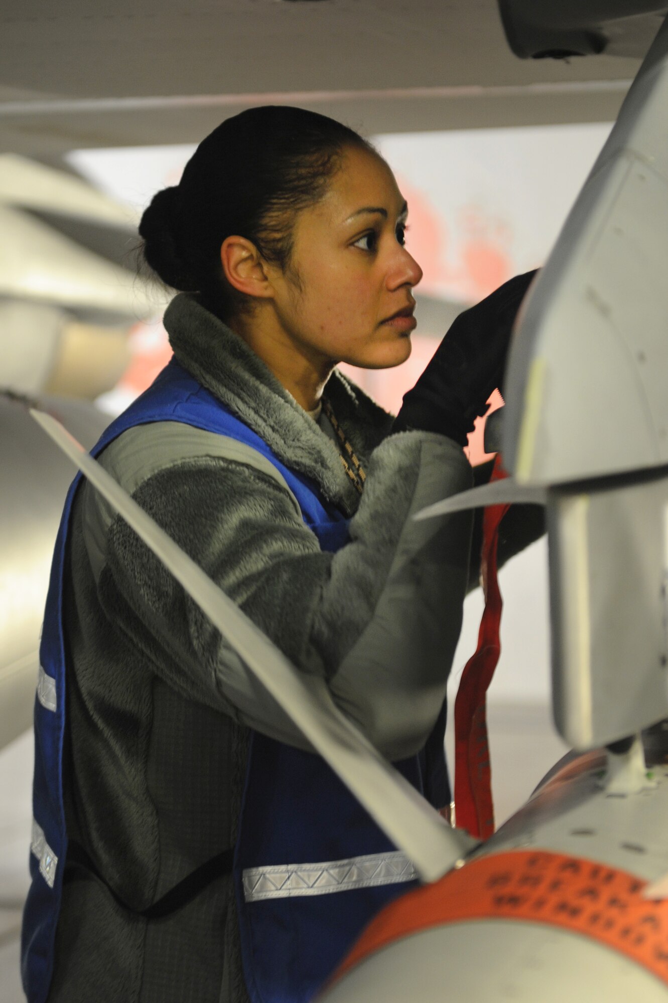 U.S. Air Force Tech. Sgt. Monique Duverglas, 35th Maintenance Group Exercise Evaluation Team member, evaluates the safety and serviceability of a pylon on an F-16 Fighting Falcon during an Initial Response Readiness Exercise on Jan. 10, 2013. The mission of the 35 MXG is to provide safe and reliable aircraft, equipment and munitions to train the world’s finest F-16 pilots and maintainers. Some areas that the 35th Fighter Wing is evaluated on during an IRRE include command and control, deployment processing, employment readiness, information operations and force protection.  (U.S. Air Force photo by Airman 1st Class Kia Atkins)