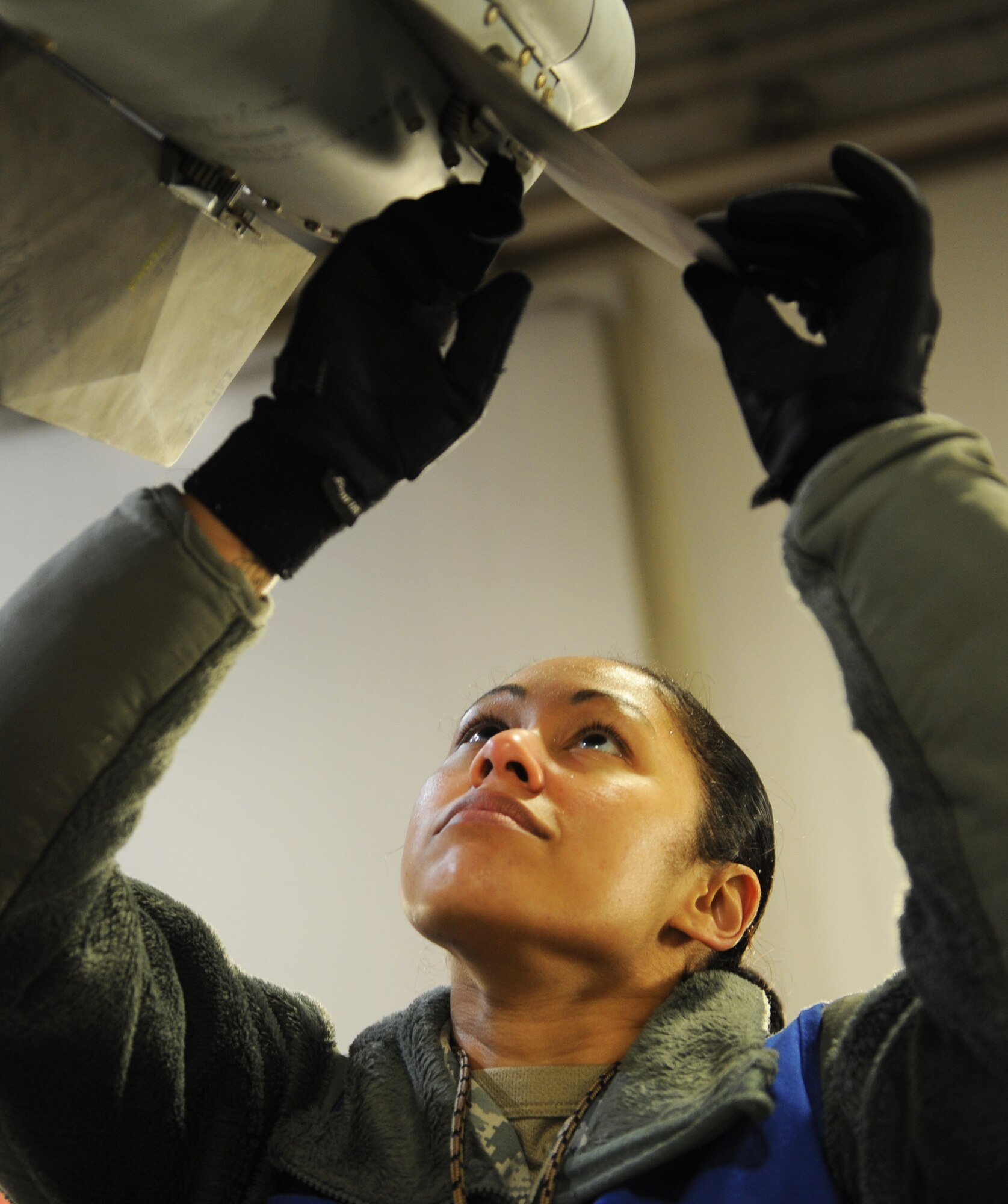 U.S. Air Force Tech. Sgt. Monique Duverglas, 35th Maintenance Group Exercise Evaluation Team member, evaluates the fins on an AIM-120 advanced medium-range air-to-air missile on an F-16 Fighting Falcon during an Initial Response Readiness Exercise on Jan. 10, 2013. Weapons crew load members install the missile and Duverglas inspects it to ensure the safety and readiness of the aircraft. An IRRE is used to evaluate the wing on its ability to organize and activate from peacetime readiness to wartime posture on short notice. (U.S. Air Force photo by Airman 1st Class Kia Atkins)