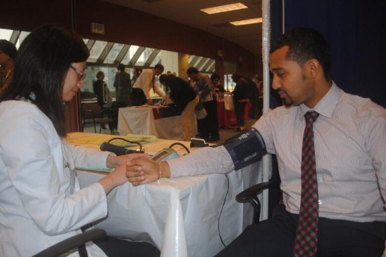 Wincy Chow, a Federal Occupational Health nurse, checks the blood pressure of Rede Shifferaw, a contract specialist with the U.S. Army Corps of Engineers San Francisco District. 

