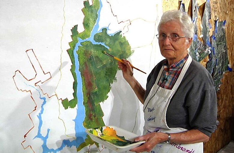 Local artist Marge Gray paints a mural of Lake Sonoma for the new Milt Brandt Visitor Center.