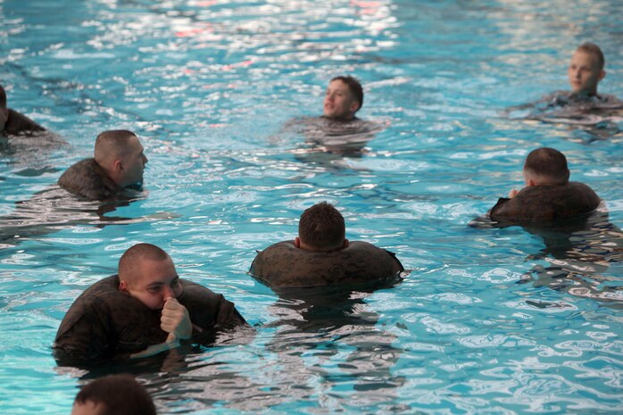 Marines with Combat Logistics Regiment 27, 2nd Marine Logistics Group use their uniforms as flotation devices during the unit’s swim qualification aboard Camp Lejeune, N.C., Jan. 8, 2013. In the intermediate qualification, Marines had to stay afloat for 10 minutes. 