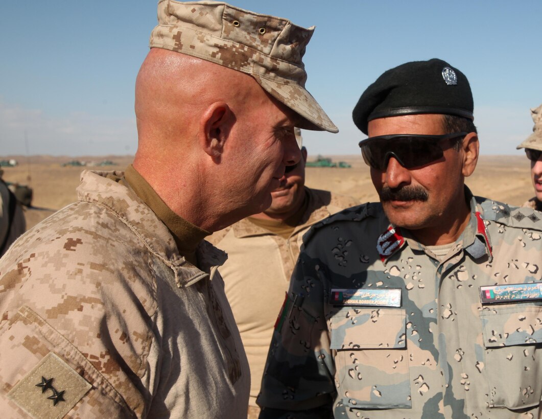 Major Gen. David Berger, the Task Force Leatherneck commanding general, speaks with Col. Hamidullah Sadiki, the 6th Zone Afghan Border Police chief of staff, during an operations brief in southern Helmand province, Afghanistan, Dec. 9. During the past five days, the 6th Zone ABP has been conducting a clearing operation and has had success accomplishing their mission. Major Gen. Berger, as well as other government and coalition officials, visited the operation’s command center to see the progress the ABP has made.