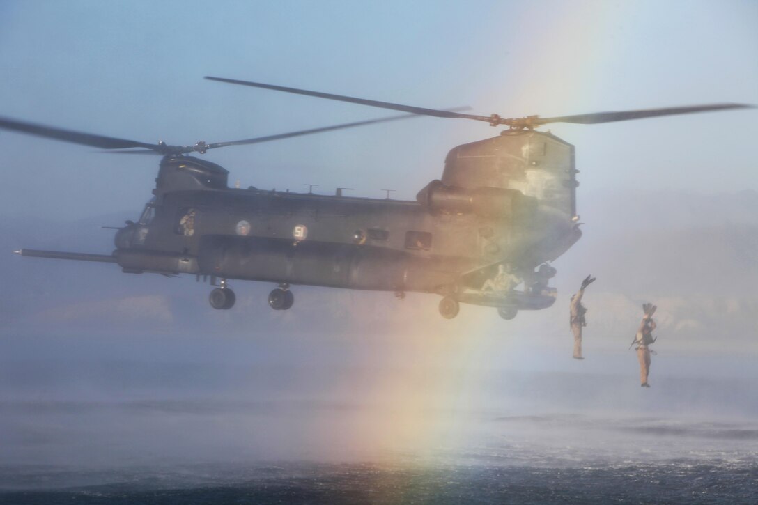 Marines with the 1st Marine Special Operations Battalion, U.S. Marine Corps Forces, Special Operations Command helocast from a CH-47 helicopter during Visit, Board, Search and Seizure (VBSS) training with the 160th Special Operations Aviation Regiment near Camp Pendleton, Calif., Dec. 11. VBSS, which consists of maritime vessel boarding and searching, is used to combat smuggling, drug trafficking, terrorism and piracy. (U.S. Marine Corps photo by Cpl. Kyle McNally/Released)