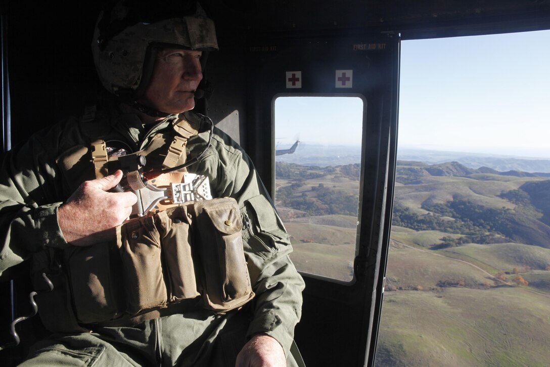 Lt. Gen. John A. Toolan, the commanding general of I Marine Expeditionary Force, looks at the landscape during a familiarization flight in a UH-1Y Huey with the Marine Light Helicopter Squadron 369 “Gunfighters” aboard Marine Corps Air Station Camp Pendleton, Calif., Jan. 8. During the flight Toolan fired the M-2 .50 caliber machine gun, a GAU-17 mini-gun and the LAU-68F/A laser-guided weapons system.