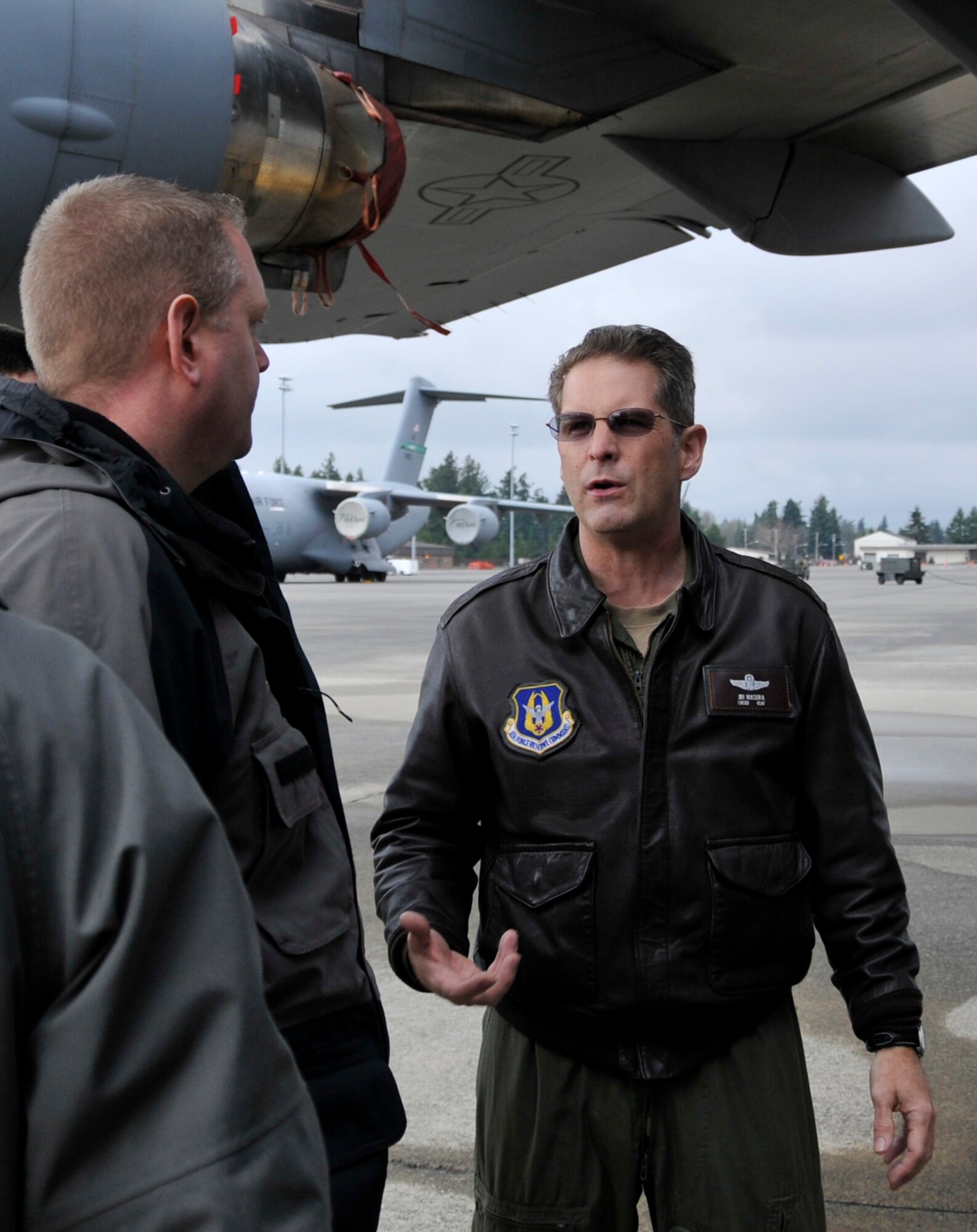 Chief Master Sgt. Jim Masura (right) 446th Operations Group standardization and evaluation loadmaster, provides a member of the Pierce County Metro Dive Team from Tacoma, Wash. with an orientation on the capabilities and various entry and exit points of the C-17 Globemaster III at McChord Field, Wash., Jan. 10, 2013. The dive team visited McChord to receive training on the aircraft, so they would be ready for an incident response in the case of an off-base water landing. (U.S. Air Force photo by Master Sgt. Jake Chappelle)