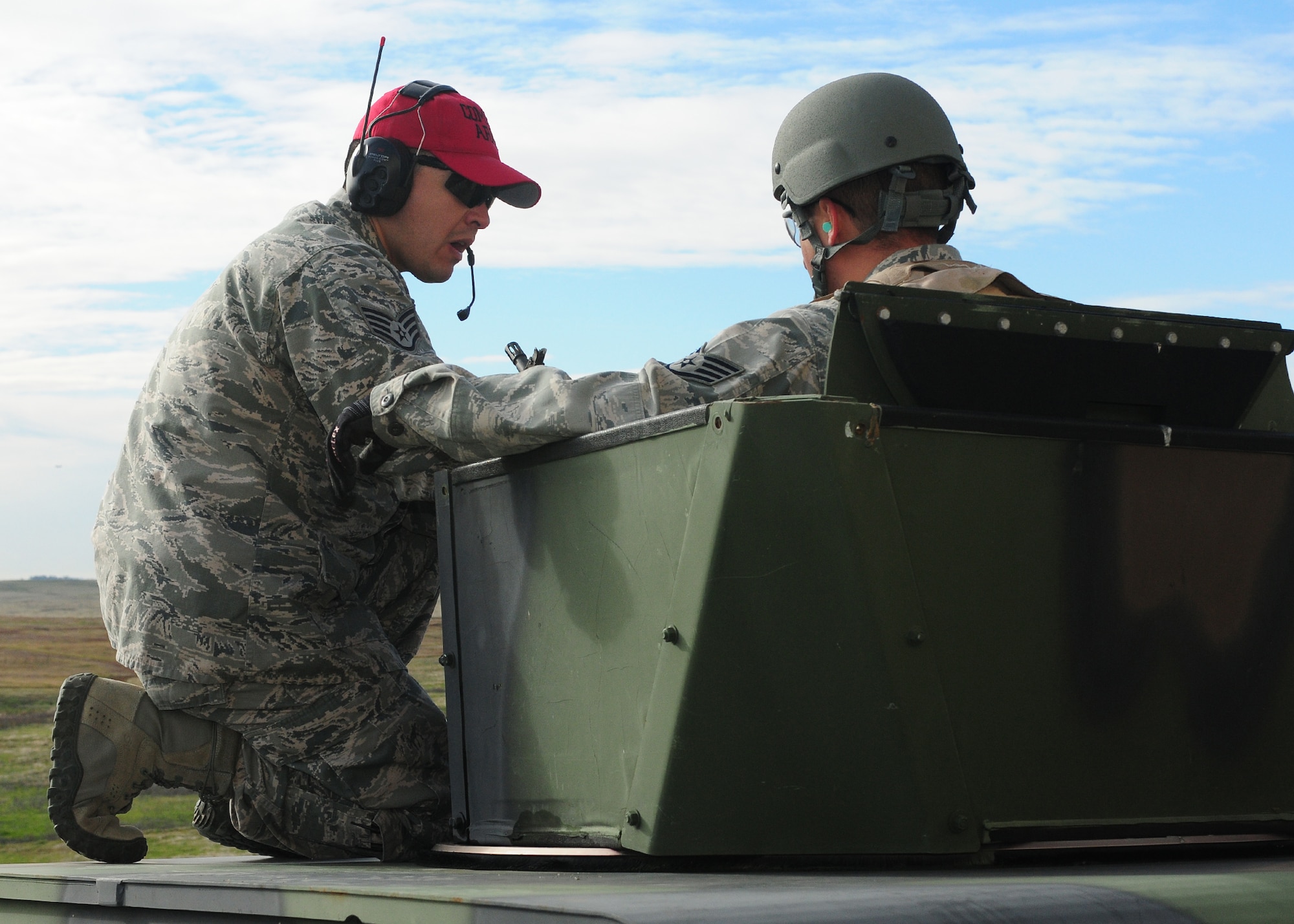 Staff Sgt. Angel Madrigal (left), 9th Security Forces Squadron combat arms instructor, informs Staff Sgt. Jay Weber, 9th Munitions Squadron munitions inspector, how to operate the M-240B light machine gun while mounted to a Humvee at the heavy weapons range at Beale Air Force Base, Calif., Jan. 11, 2013. The M-240B can be fired from the ground or a Humvee. (U.S. Air Force photo by Senior Airman Allen Pollard/Released)