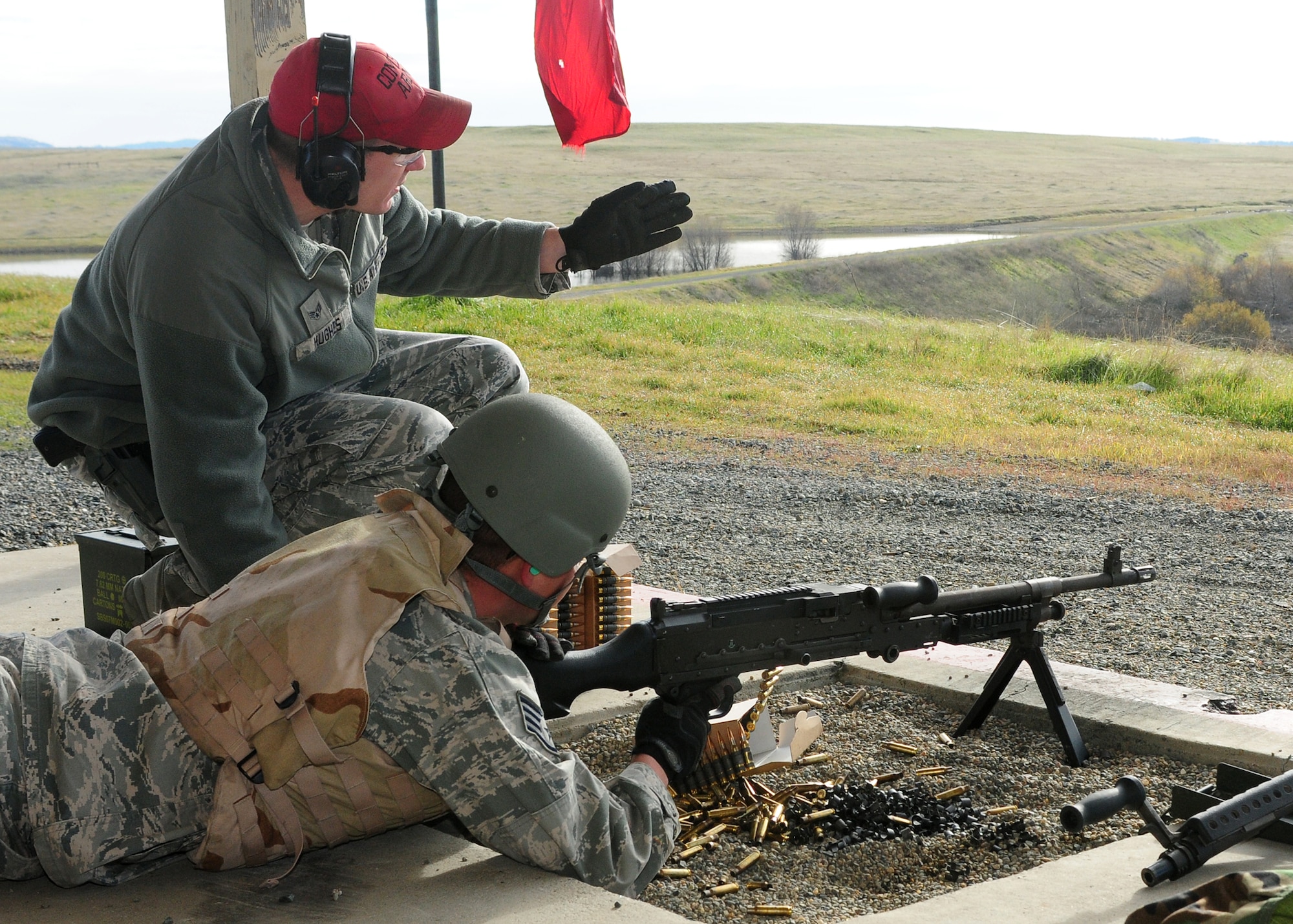 Senior Airman Michael Hughes (above), 9th Security Forces Squadron combat arms instructor, instructs Staff Sgt. Jay Weber, 9th Munitions Squadron munitions inspector, where to aim during heavy weapons training at Beale Air Force Base, Calif., Jan. 11, 2013. Weber was firing the M-240B light machine gun. (U.S. Air Force photo by Senior Airman Allen Pollard/Released)