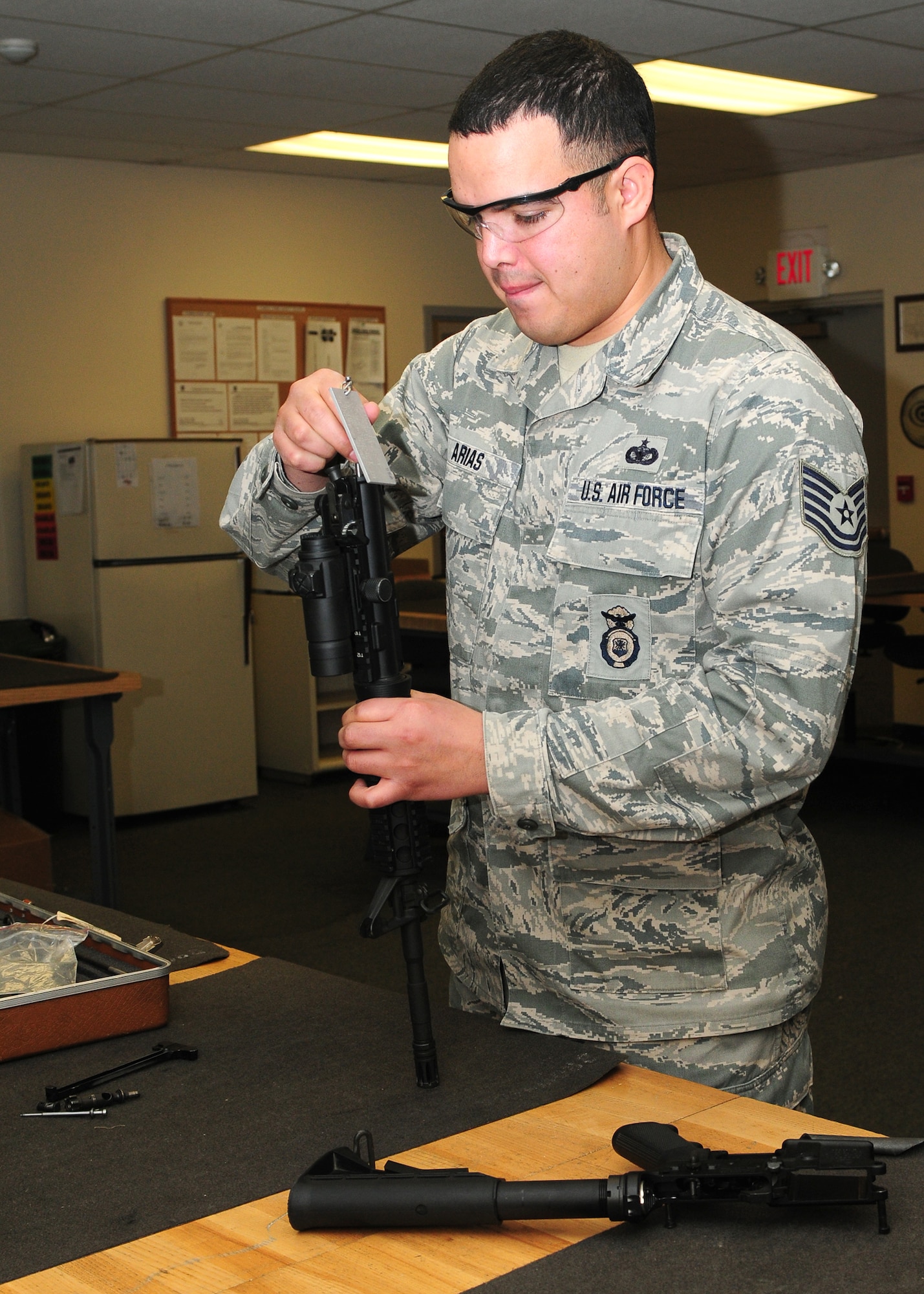 Tech. Sgt. Jesus Arias, 9th Security Forces Squadron NCO in charge of combat arms, breaks down and cleans a M-4 carbine assault rifle at the combat arms facility on Beale Air Force Base, Calif., Jan. 10, 2013. The combat arms instructors are in charge of training and qualifying Team Beale with small arms. (U.S. Air Force photo by Senior Airman Allen Pollard/Released)