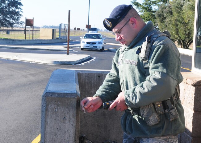 Airman 1st Class Daniel Prince, 9th Security Forces Squadron gate guard, checks IDs at the Wheatland Gate on Beale Air Force Base, Calif., Jan. 10, 2013. Security Forces Airmen are posted at all gates to prevent any unauthorized access to the base. (U.S. Air Force photo by Senior Airman Allen Pollard/Released)
