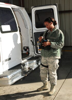 Senior Airman Alicia Momon-Jones, 9th Security Forces Squadron leader, uses a portable explosive detection device during an inspection at the contractor vehicle inspection area on Beale Air Force Base, Calif., Jan. 10, 2013. Security Forces inspects all contractor vehicles before they can enter the base. (U.S. Air Force photo by Senior Airman Allen Pollard/Released)
