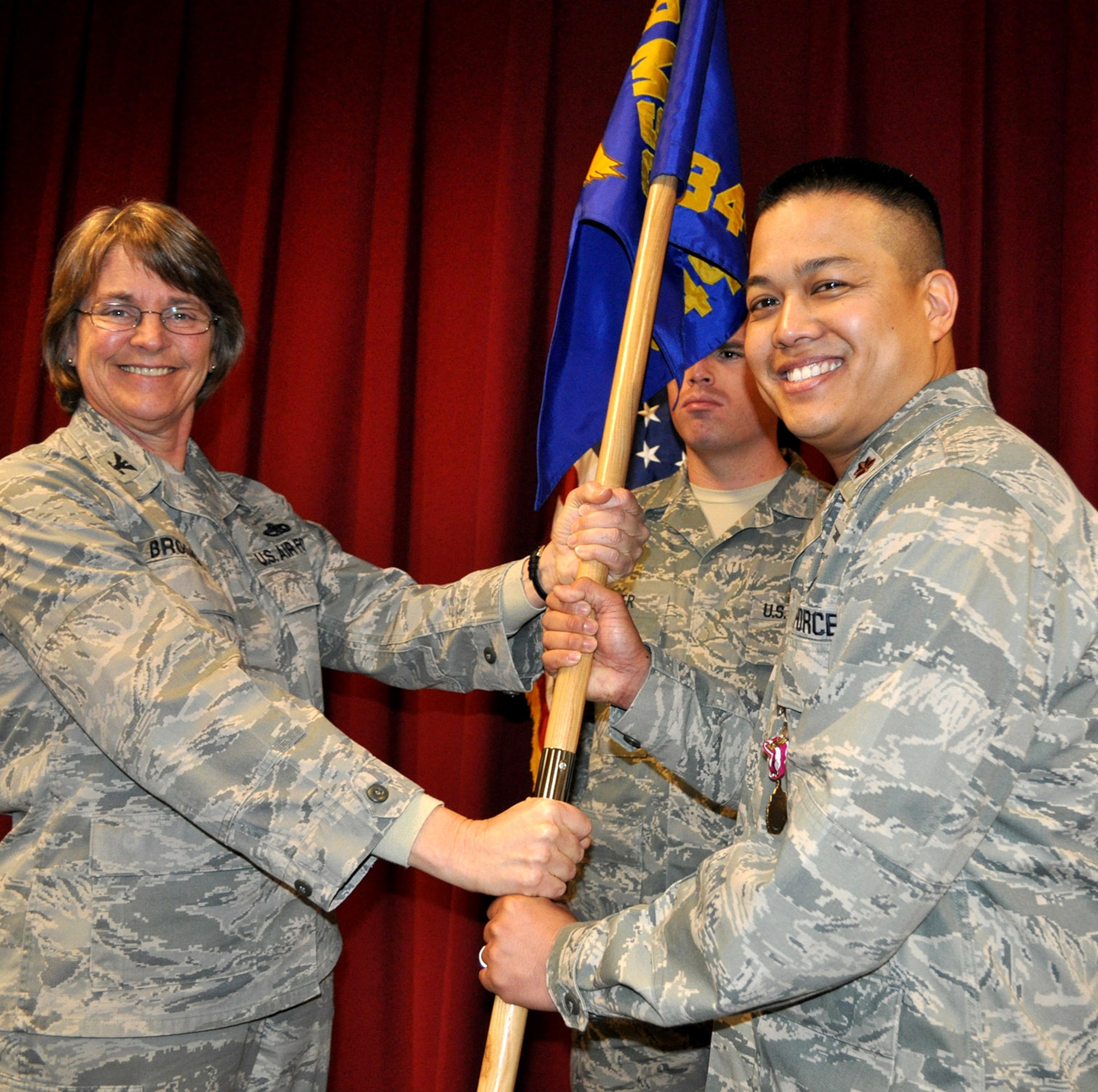 TRAVIS AIR FORCE BASE, Calif. -- With the passing of the squadron guidon, Maj. Melvin Ibarreta assumed command of the 349th Civil Engineer Squadron from Mission Support Group commander Col. Nancy Brooks. Waiting to receive the guidon back is Staff Sgt. Jared Bayer. Ibarreta has been assigned to the squadron for 10 years, and has known some of his Airmen that long. His first important task is to prepare them for the February operational readiness inspection. (U.S. Air Force photo/Senior Master Sgt. Ellen Hatfield)