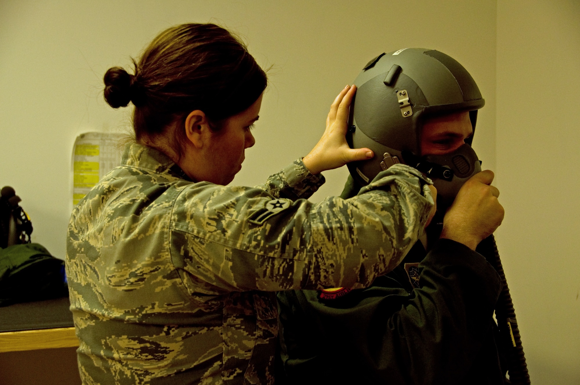Airman 1st Class Lindsy Hall, 60th Operations Support Squadron aircrew
flight equipment apprentice, runs a series of tests over Staff Sgt. Chris
Sabelky's, 21st Airlift Squadron, oxygen mask. The test included simulations
of varying altitudes to ensure the mask was safe and functioning at any
elevation. (U.S. Air Force photo/Airman 1st Class Madelyn Brown)
