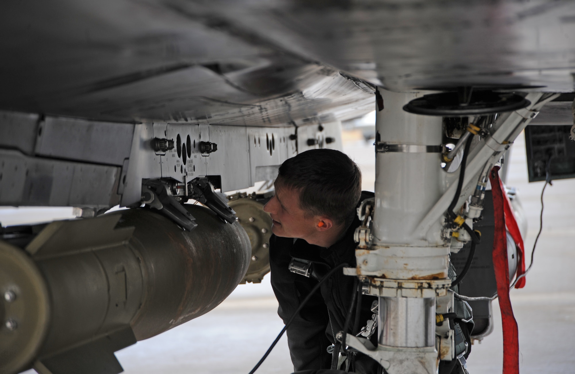 Capt. Brett Black, 389th Fighter Squadron B Flight commander, checks the mounting brackets on a MK-82AR munition Dec. 12, 2012 at Mountain Home Air Force Base, Idaho. In order to ensure safety, additional care is taken to deliver mission success. (U.S. Air Force photo/Senior Airman Benjamin Sutton)
