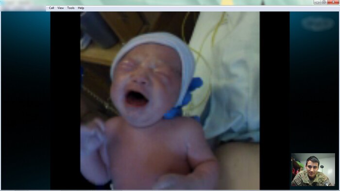Staff Sgt. Daniel, a deployed Beale Airman, sees his daughter Avery for the first time from his deployed location after video chatting with his wife Robyn through 14 hours of labor. (Courtesy photo)