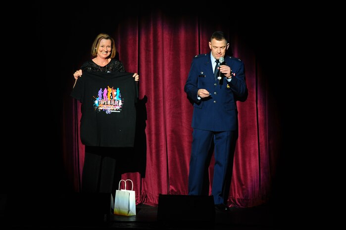 Col. Richard McComb, Joint Base Charleston commander, announces the winners of the T-shirt give-away  before the  Tops in Blue show Jan. 9, 2013, at the North Charleston Performing Arts Center, S.C. Composed of 35 to 40 talented vocalists, musicians, dancers and technicians, their primary mission is to perform for military personnel and their families throughout the world. (U.S. Air Force photo/ Airman 1st Class Chacarra Walker)
