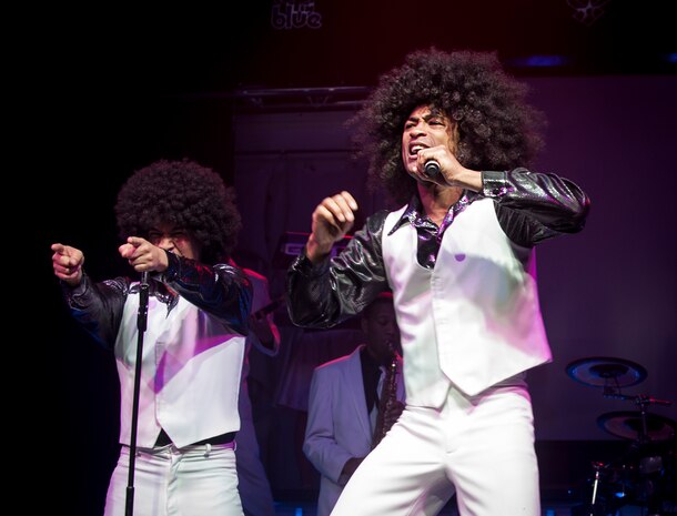 Airman 1st Class Joseph Kay and Senior Airman Charles Cooper perform at the Tops in Blue show Jan. 9, 2013, at the North Charleston Performing Arts Center, S.C. Composed of 35 to 40 vocalists, musicians, dancers and technicians , the group’s primary mission is to perform for military personnel and their families around the world. This year's tour took Tops in Blue throughout the United States and to more than 20 countries with approximately 130 performances during a 10-month period. (U.S. Air Force photo/Airman 1st Class Ashlee Galloway)