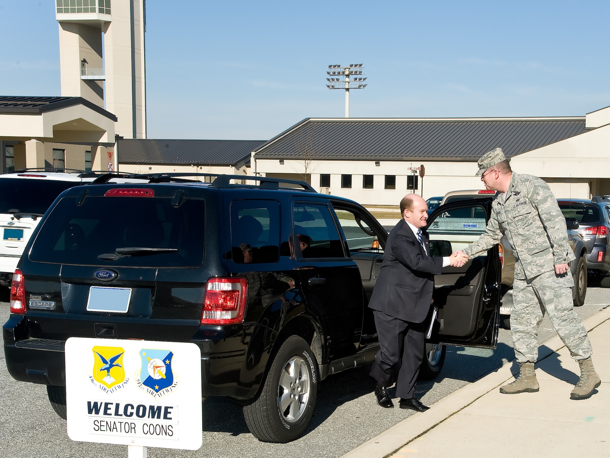 Delaware Senator Christopher Coons, left, is greeted by Col. Rick Moore, commander of the 436th Airlift Wing, Jan. 10, 2013, at Dover Air Force Base, Del. Coons received a briefing by wing leadership on energy and cost saving initiatives. (U.S. Air Force photo/Roland Balik)