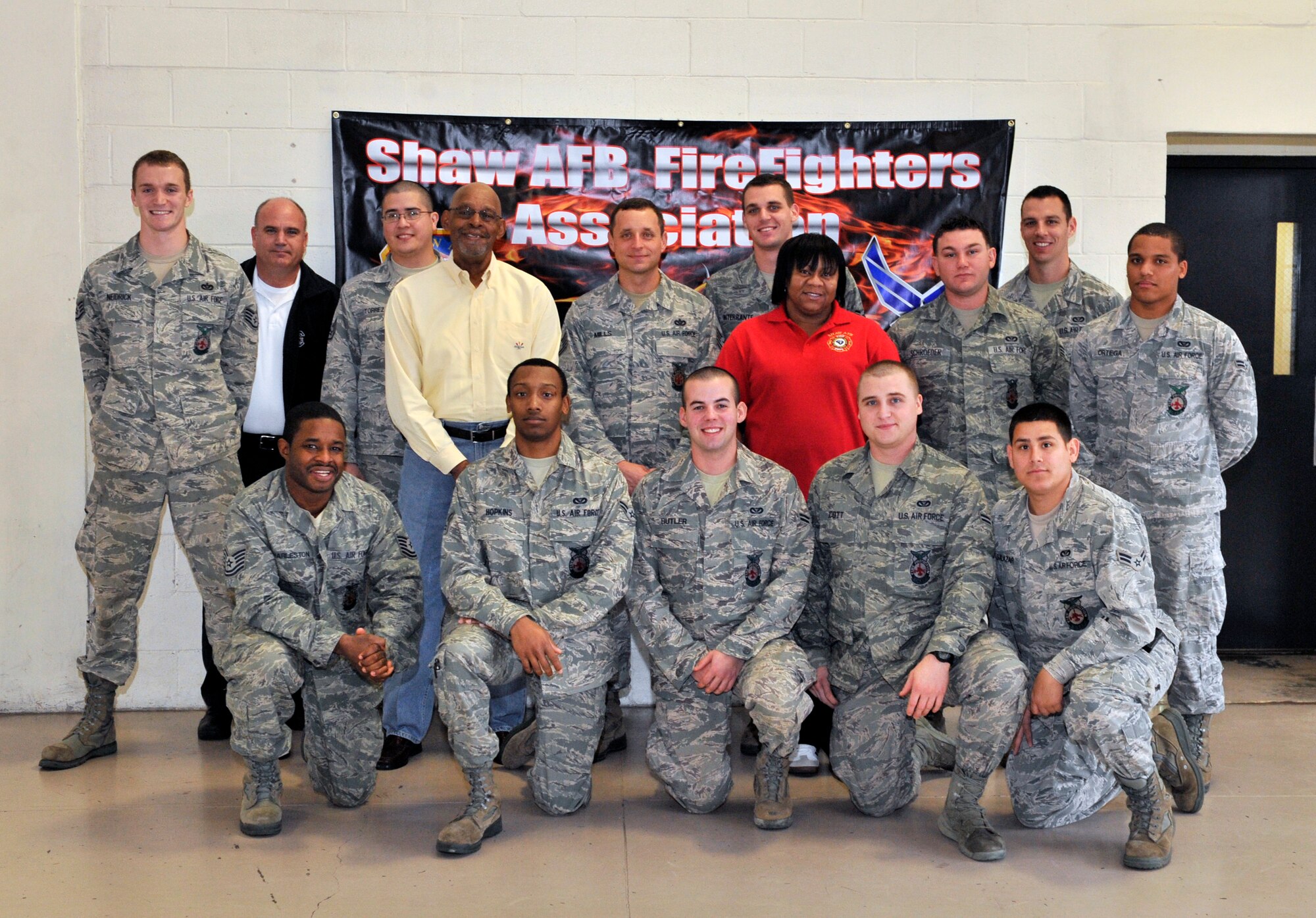Members from the 20th Fighter Wing fire department pose with Benjamin Bailey, executive director of The Salvation Army Boys and Girls Club, Shaw Air Force Base, S.C., Jan. 11, 2013. The Shaw AFB Firefighters Association honored the Boys and Girls Club by donating electronics and video games to the club.  (U.S. Air Force photo by Senior Airman Amber E. N. Jacobs/ Released) 