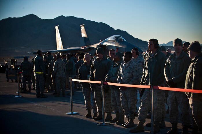 Airmen from the 57th Wing observe the load crew competition Jan. 11, 2013, at Nellis Air Force Base, Nev. Airmen from each Aircraft Maintenance Unit attended to support their fellow weapons load crew teams.(U.S. Air Force photo/Senior Airman Brett Clashman)