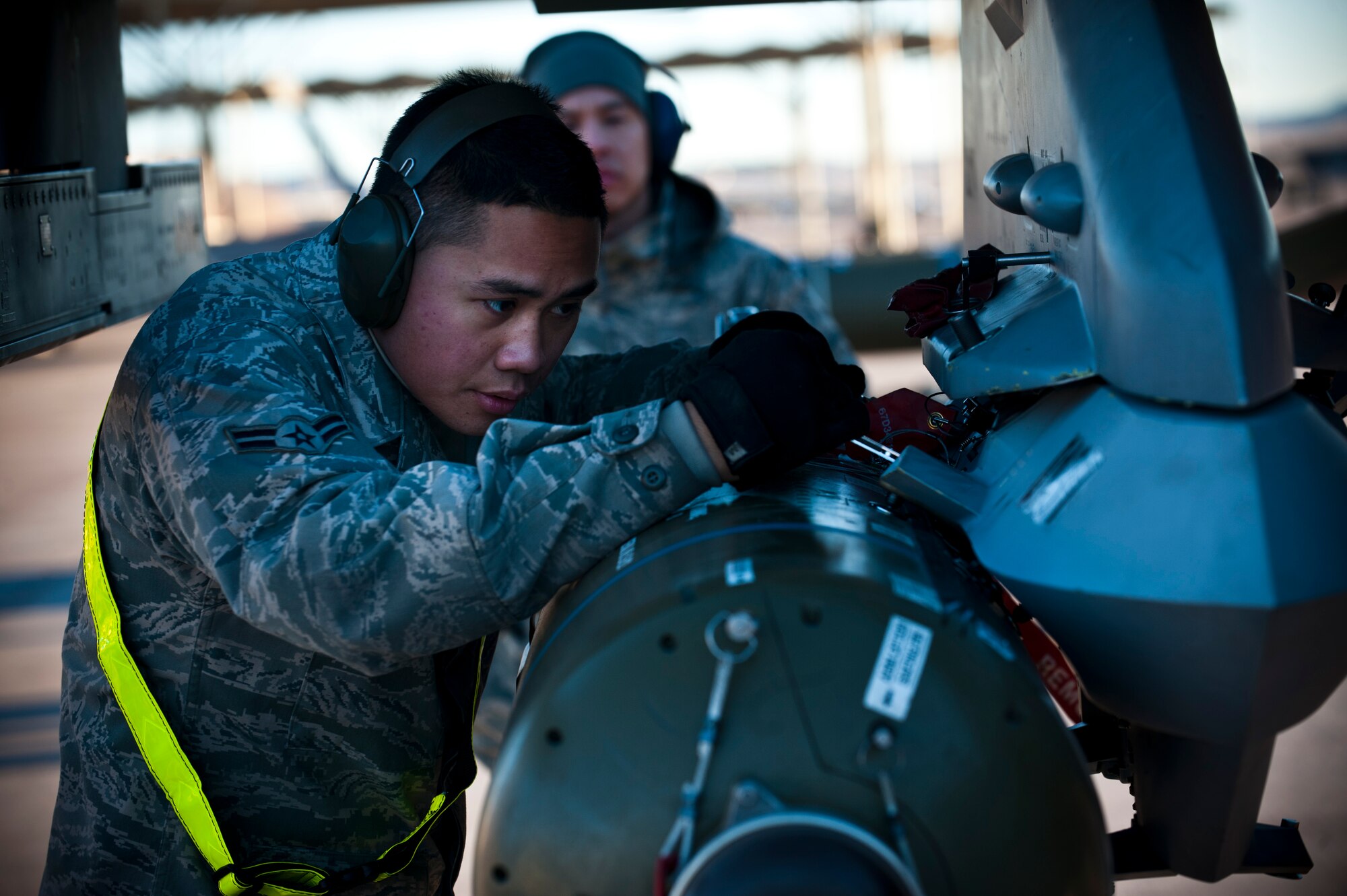 Airman 1st Class Ryan Duarte inspects a CBU-89 bomb during a load crew competition Jan. 11, 2013, at Nellis Air Force Base, Nev. The load crew competition helps promote teamwork and morale. (U.S. Air Force photo/Senior Airman Brett Clashman)