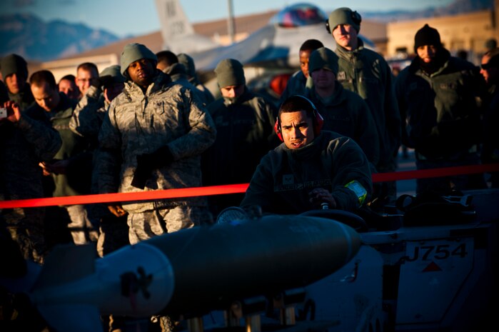 Senior Airman Jonathon Gonzalez operates a weapon loader during a load crew competition Jan. 11, 2013, at Nellis Air Force Base, Nev. Weapons load competitions are conducted quarterly to keep Airmen sharp and recognize superior performers. (U.S. Air Force photo/Senior Airman Brett Clashman)