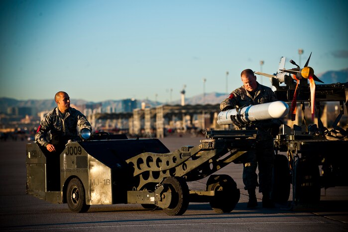 Senior Airman Chris Wright and Staff Sgt. Cory Moody, 757th Aircraft Maintenance Squadron aircraft armament systems technicians, prepare to load an AIM-7 Sparrow air-to-air missile during a load crew competition Jan. 11, 2013, at Nellis Air Force Base, Nev. Airmen participate in the annual competition for title of load crew of the year. (U.S. Air Force photo/Senior Airman Brett Clashman)