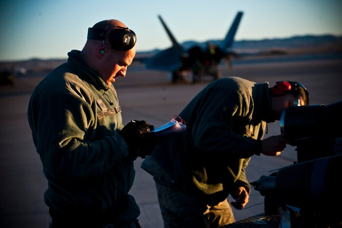 Staff Sgt. Geoffrey Mood, 757th Aircraft Maintenance Squadron aircraft armament systems technician, reads through a checklist during a load crew competition Jan. 11, 2013, at Nellis Air Force Base, Nev. The competition provides different aircraft squadrons the opportunity to display their skills to the 57th Wing commander. (U.S. Air Force photo/Senior Airman Brett Clashman)