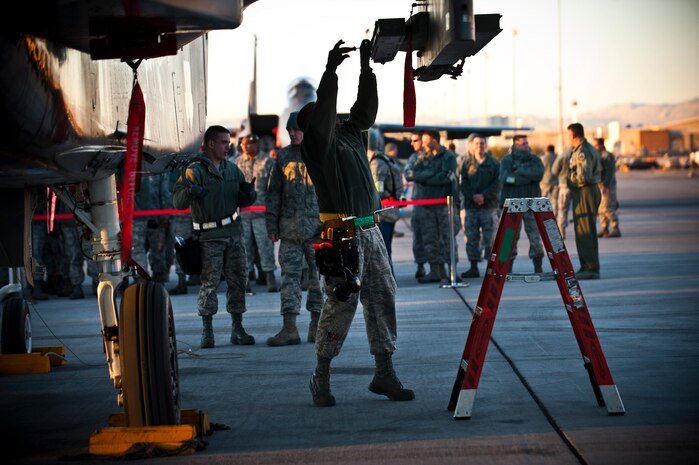 Airman Jonathon Deacon, 57th Aircraft Maintenance Squadron aircraft armament systems technician, prepares an F-15 Eagle for uploading munitions during a load crew competition Jan. 11, 2013, at Nellis Air Force Base, Nev. The annual weapons load crew competition tests the skills of Airmen from Viper, Thunder, Raptor, Falcon, Eagle, Tomahawk and Strike Aircraft Maintenance Units. (U.S. Air Force photo/Senior Airman Brett Clashman)