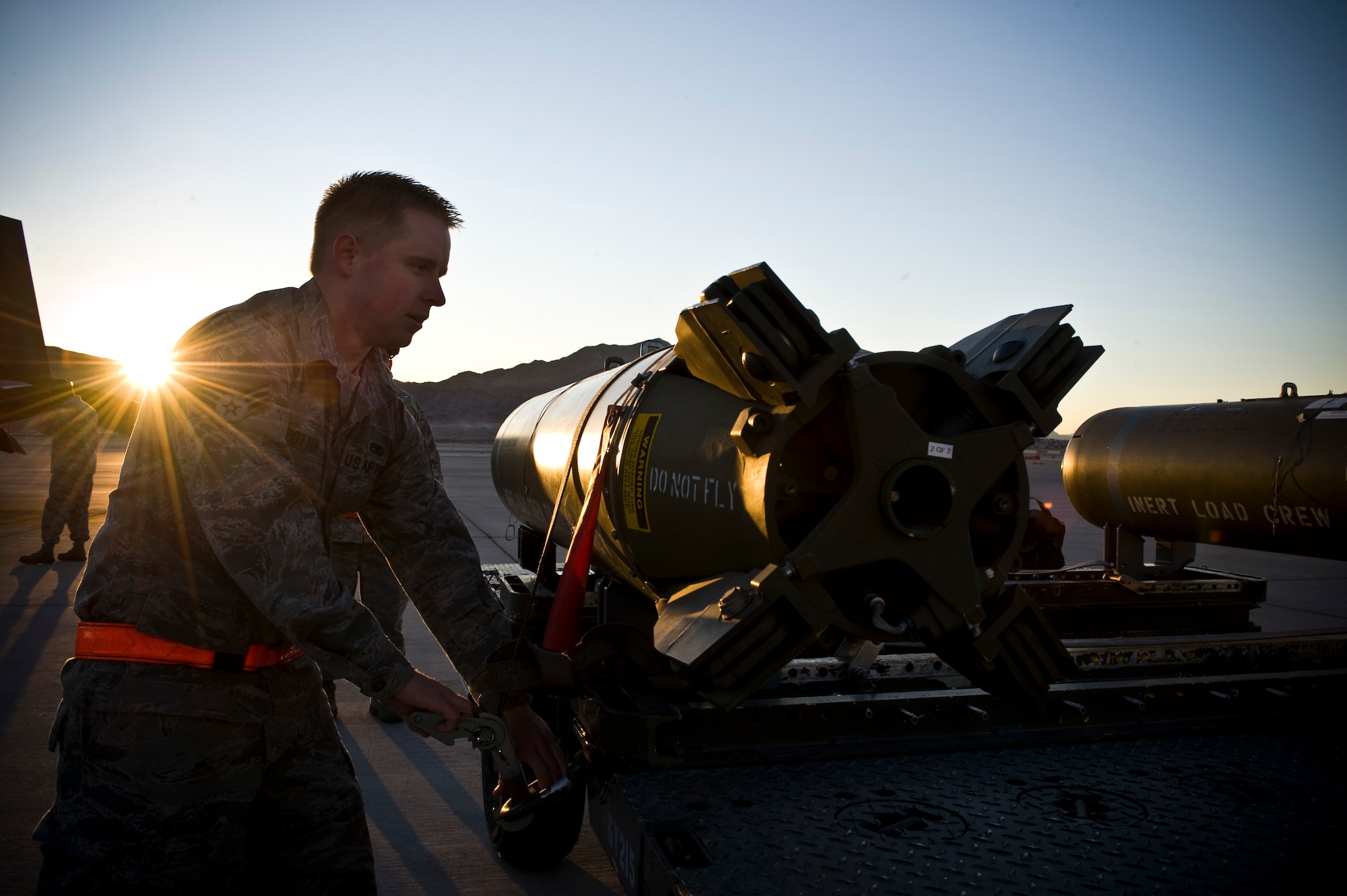 Senior Airman Jesse Potter, 57th Aircraft Maintenance Squadron aircraft armament systems technician, prepares to load a CBU-89 bomb during the load crew competition of the year Jan. 11, 2013, at Nellis Air Force Base, Nev. Load crew competitions promote teamwork and morale among team members. (U.S. Air Force photo by Airman 1st Class Christopher Tam)