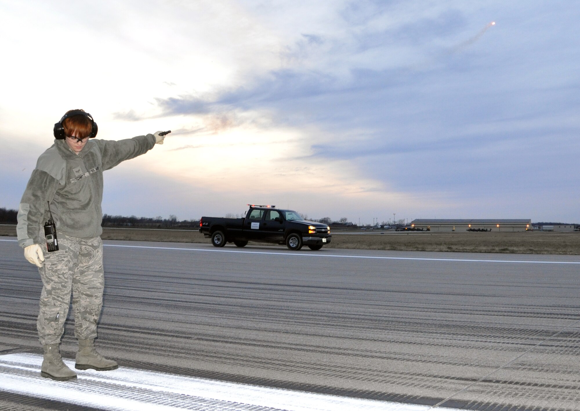 Airman 1st Class Hannah A. Schmitz, 509th Operations Support Squadron airfield managment shift lead, fires a bird-deterrence flare on the runway here, Jan. 9, 2013. The equipment is part of the bird airfield strike hazard program, which was instituted to deter bird-strikes on base aircraft. The 509th OSS is part of the 509th Bomb Wing, an Air Force Global Strike Command active duty unit here. (U.S. Air Force Photo by Senior Airman Wesley Wright/Released)