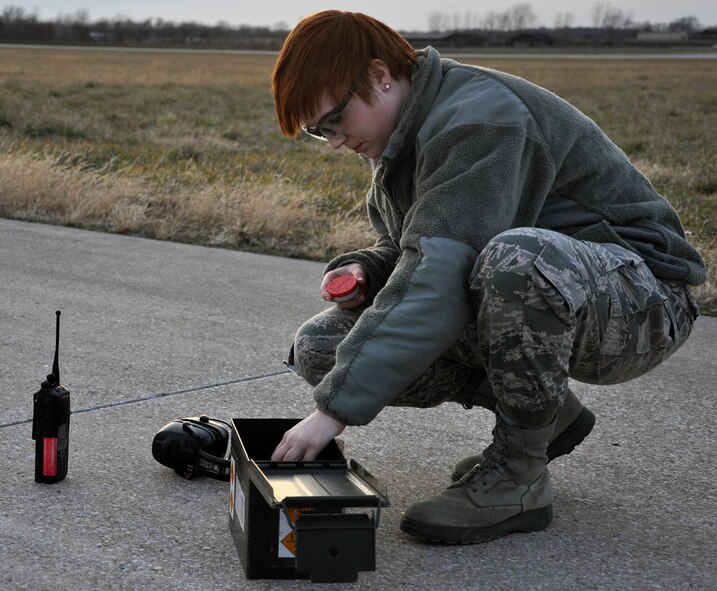 Airman 1st Class Hannah A. Schmitz, 509th Operations Support Squadron airfield managment shift lead, checks her bird-deterrence equipment on the runway here, Jan. 9, 2013. The equipment is part of the bird airfield strike hazard program, which was instituted to deter bird-strikes on base aircraft. The 509th OSS is part of the 509th Bomb Wing, an Air Force Global Strike Command active duty unit here. (U.S. Air Force Photo by Senior Airman Wesley Wright/Released)