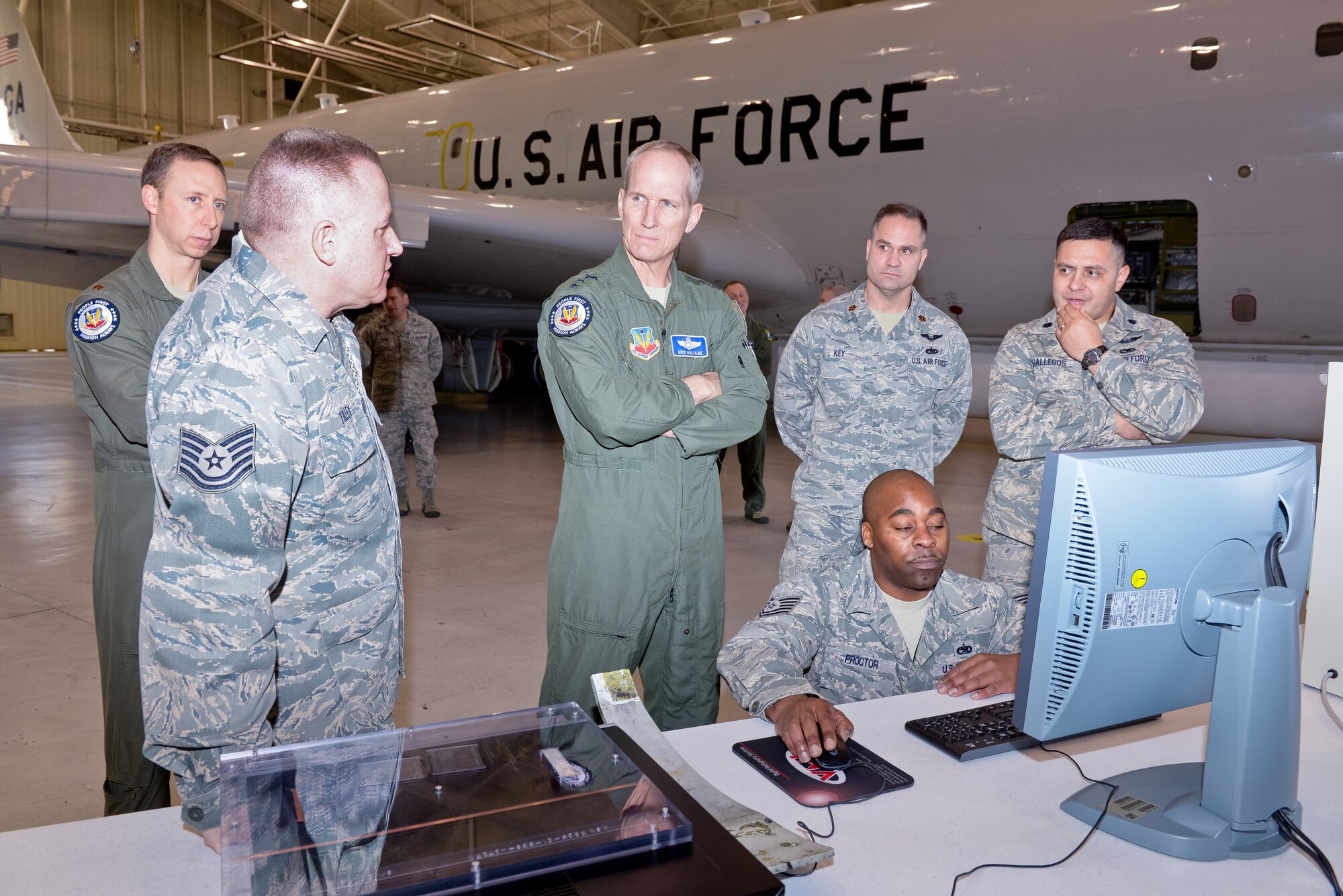 Air National Guard Tech. Sgt. Herbert Tilley, 116th Maintenance Squadron, left, briefs U.S Air Force Gen. Mike Hostage, commander, Air Combat Command, center, during a hands-on E-8C Joint STARS maintenance demonstration in the isochronal inspection dock at Robins Air Force Base, Ga., Jan. 7, 2013.  The demonstration was a part of a two-day Team JSTARS visit where Hostage received mission briefs, toured the E-8C, and conducted an all-call where he awarded the Purple Heart Medal to Air National Guard Tech. Sgt. Barry Duffield from the 116th Civil Engineering Squadron, Explosive Ordnance Disposal Flight. (National Guard photo by Master Sgt. Roger Parsons/Released)