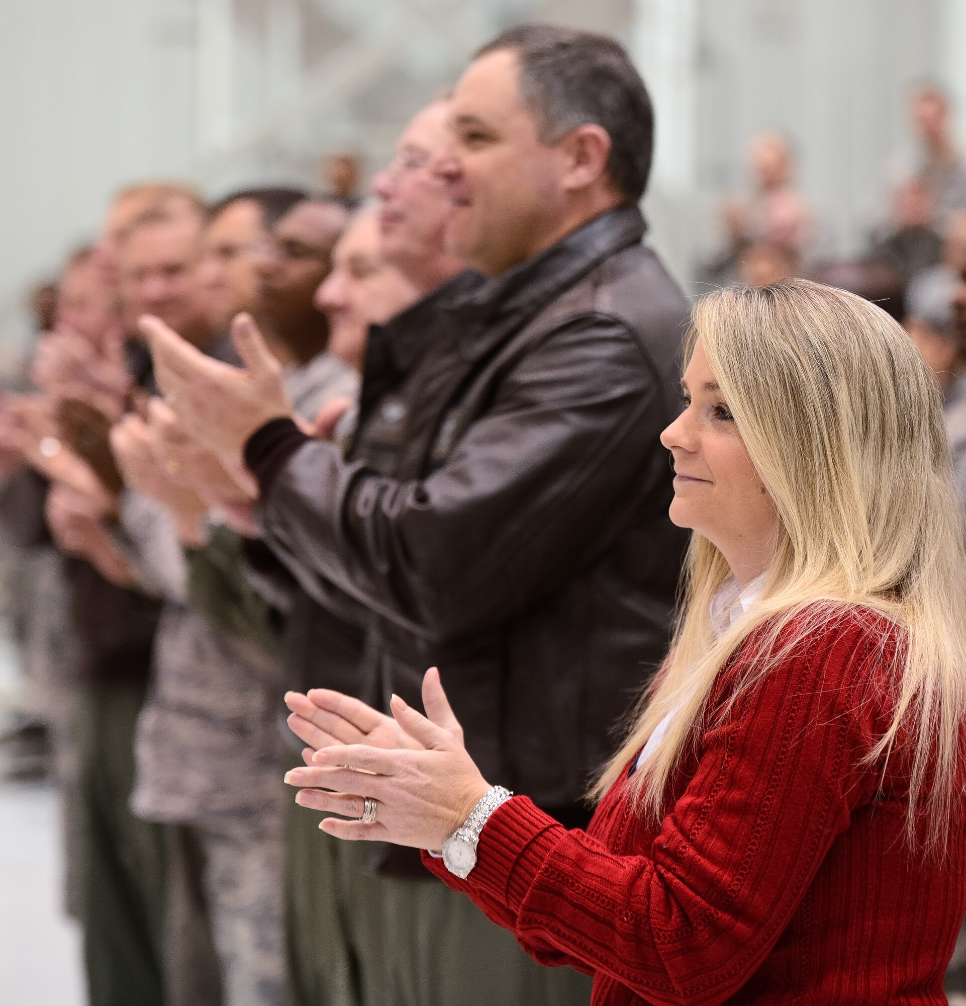 Donna Duffield, wife of Air National Guard Tech. Sgt. Barry Duffield, 116th Civil Engineering Squadron, Explosive Ordnance Disposal Flight team leader, along with Maj. Gen. Jim Butterworth, adjutant general, Georgia National Guard and other Georgia Guard leaders and members of Team Joint STARS, applaud after Tech. Sgt. Duffield received the Purple Heart Medal from U.S Air Force Gen. Mike Hostage, commander, Air Combat Command during a ceremony at Robins Air Force Base, Ga., Jan. 7, 2013.  Duffield received the medal from Hostage for injuries sustained from an Improvised Explosive Device while deployed to Afghanistan in 2011.  During the same deployment, Duffield earned the Bronze Star and Air Force Combat Action Medal.  (National Guard photo by Master Sgt. Roger Parsons/Released)