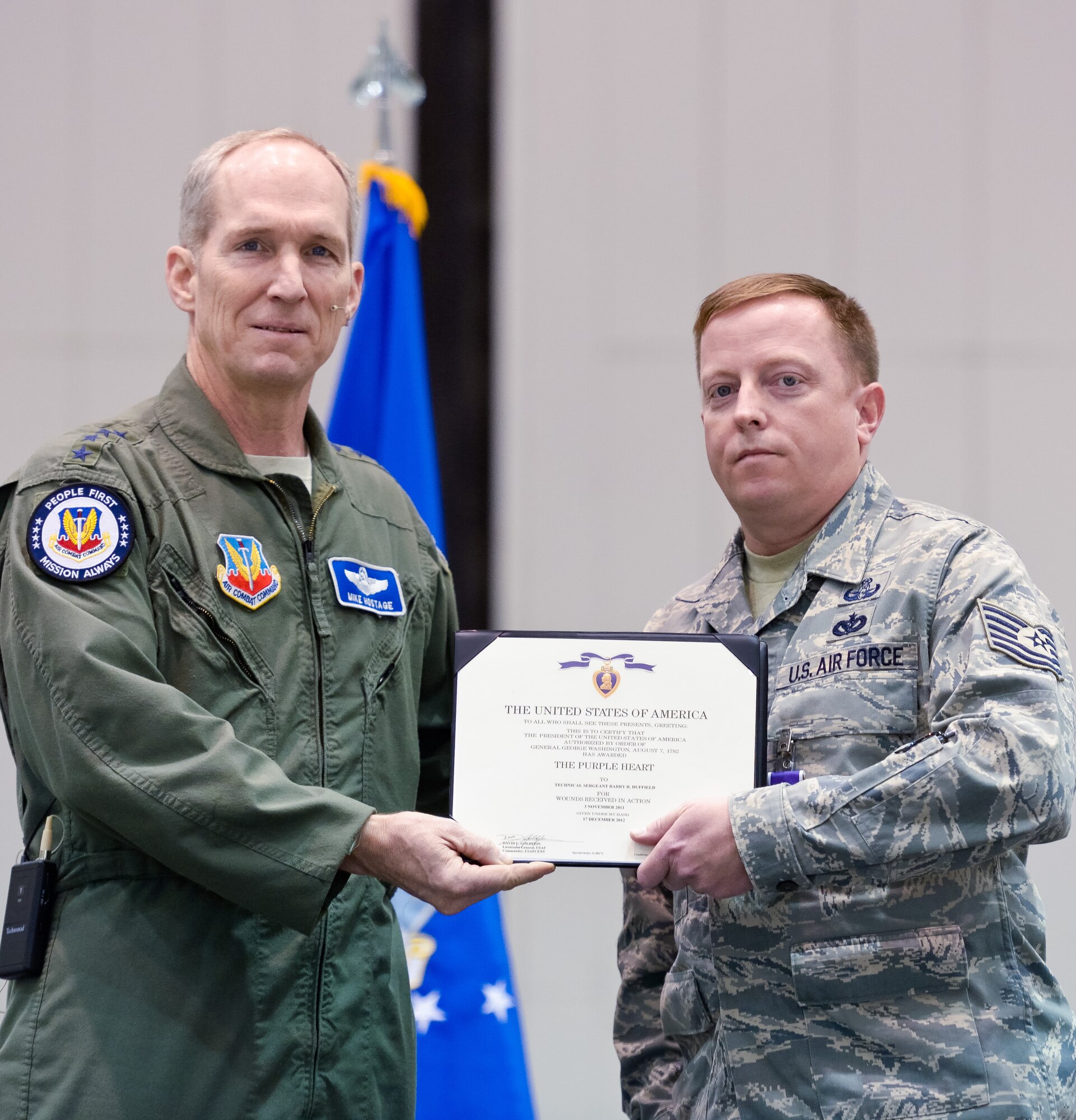 U.S Air Force Gen. Mike Hostage, commander, Air Combat Command, presents the Purple Heart Medal to Air National Guard Tech. Sgt. Barry Duffield, 116th Civil Engineering Squadron, Explosive Ordnance Disposal Flight team leader during a ceremony at Robins Air Force Base, Ga., Jan. 7, 2013.  Duffield received the medal for injuries sustained from an Improvised Explosive Device while deployed to Afghanistan in 2011.  During the same deployment, Duffield earned the Bronze Star and Air Force Combat Action Medal.  (National Guard photo by Master Sgt. Roger Parsons/Released)

