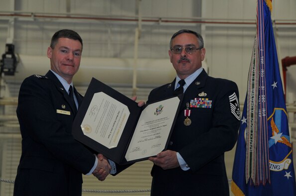 Chief Master Sgt. John Payne, 911th Airlift Wing command chief, receives a certificate of retirement from Col. Craig C. Peters, 911 AW commander, Jan. 5, 2013. Payne served 33 honorable years in the U.S. Air Force, and spent the last six years as the Command Chief of the 911 AW. His ultimate goal was to take care of the health and welfare of Airmen, as well as their individual and unit achievements.  He also stressed how vital professional military education is to the career of an Airman. (U.S. Air Force photo by Senior Airman Joshua J. Seybert/Released)