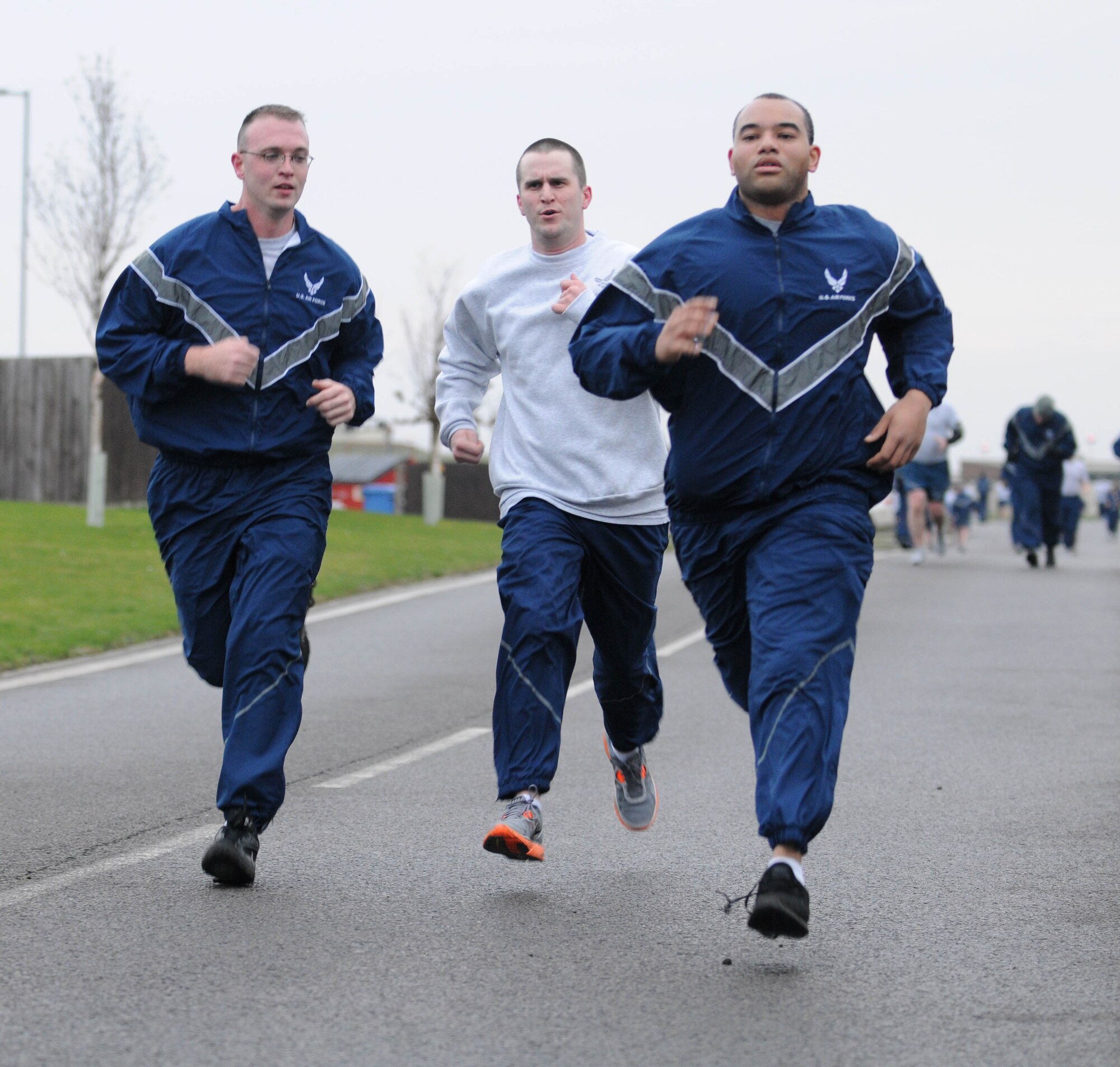 With the finish in sight, members of Team Mildenhall sprint out the last leg of the wing run Jan. 11, 2013, at RAF Mildenhall, England. The monthly 5K run encourages morale and camaraderie throughout the base through exercise and healthy competition. (U.S. Air Force photo by Staff Sgt. Austin M. May/Released)