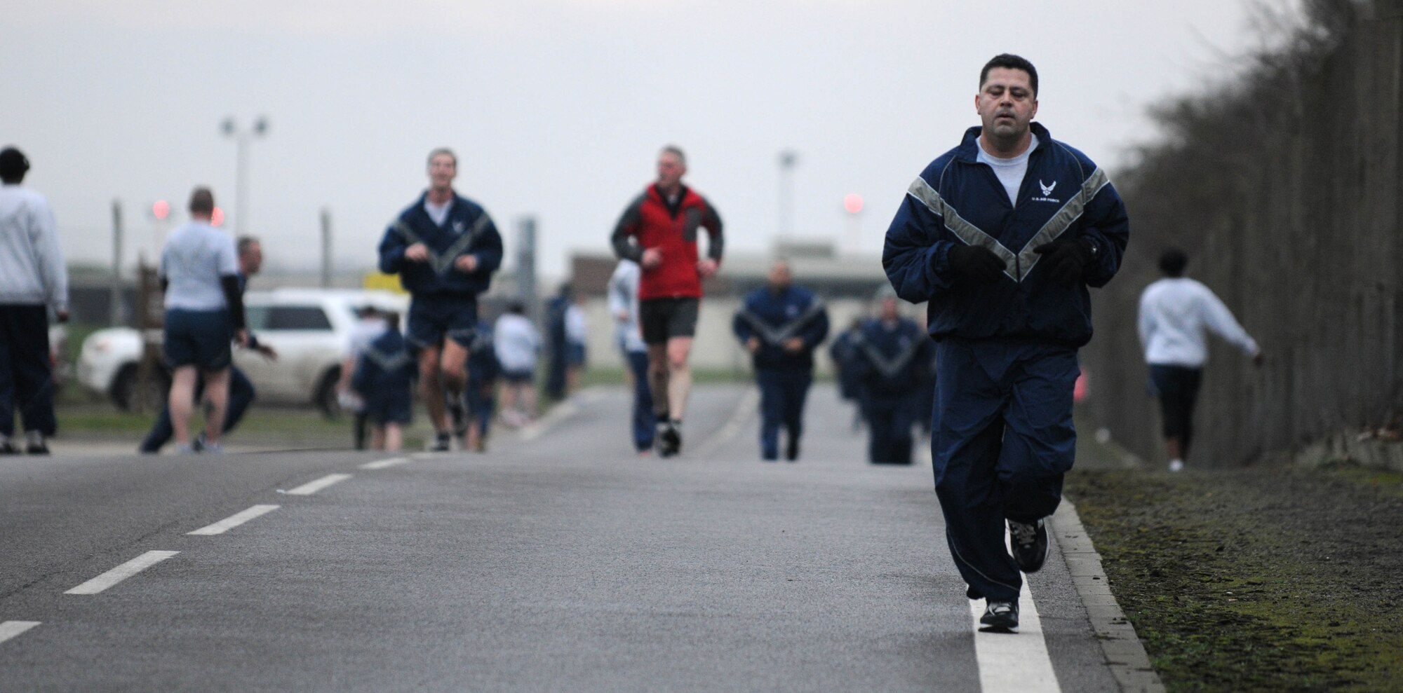 With the finish in sight, members of Team Mildenhall sprint out the last leg of the wing run Jan. 11, 2013, at RAF Mildenhall, England. The monthly 5K run encourages morale and camaraderie throughout the base through exercise and healthy competition. (U.S. Air Force photo by Staff Sgt. Austin M. May/Released)