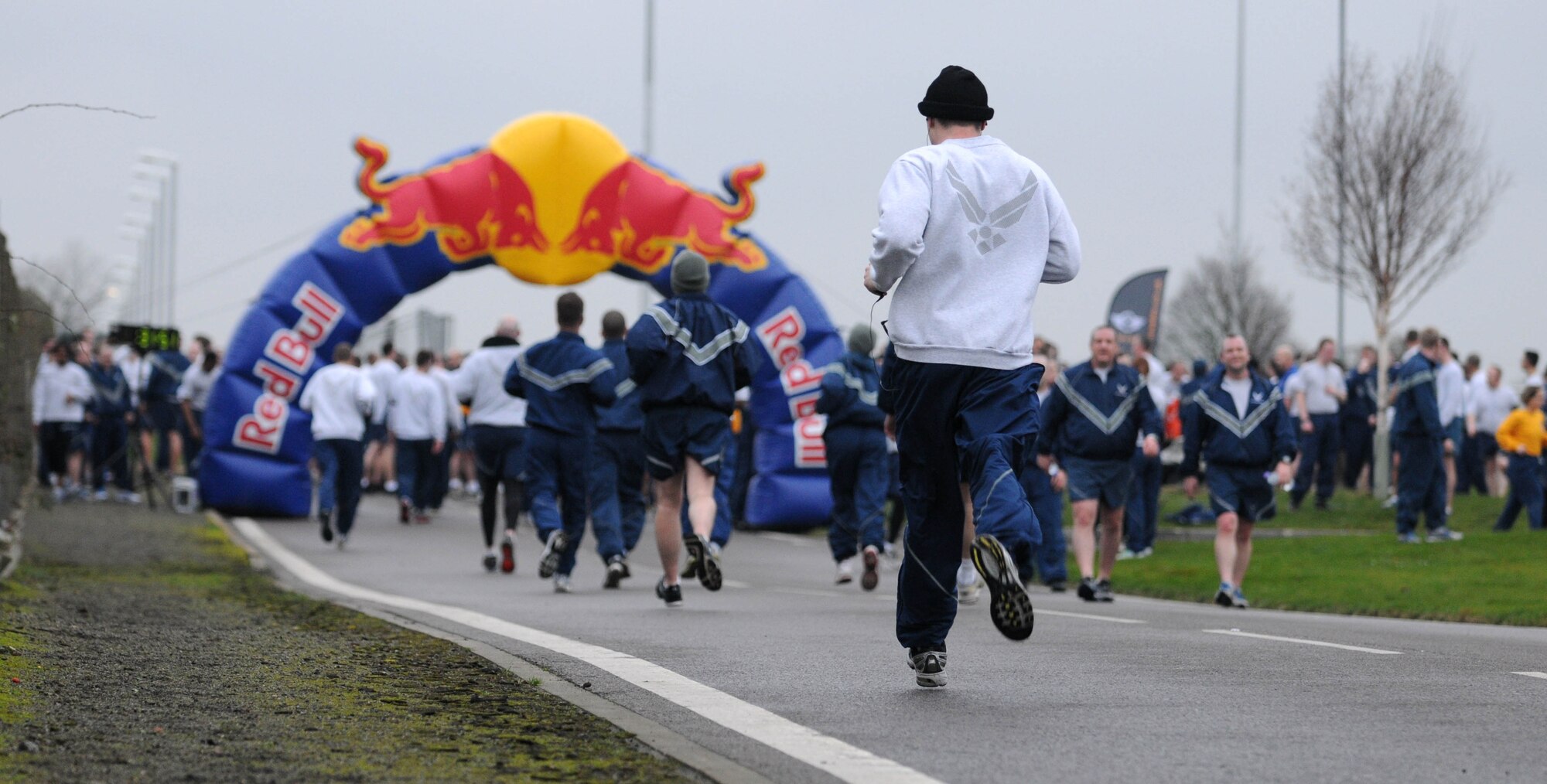 With the finish in sight, members of Team Mildenhall sprint out the last leg of the wing run Jan. 11, 2013, at RAF Mildenhall, England. The monthly 5K run encourages morale and camaraderie throughout the base through exercise and healthy competition. (U.S. Air Force photo by Staff Sgt. Austin M. May/Released)
