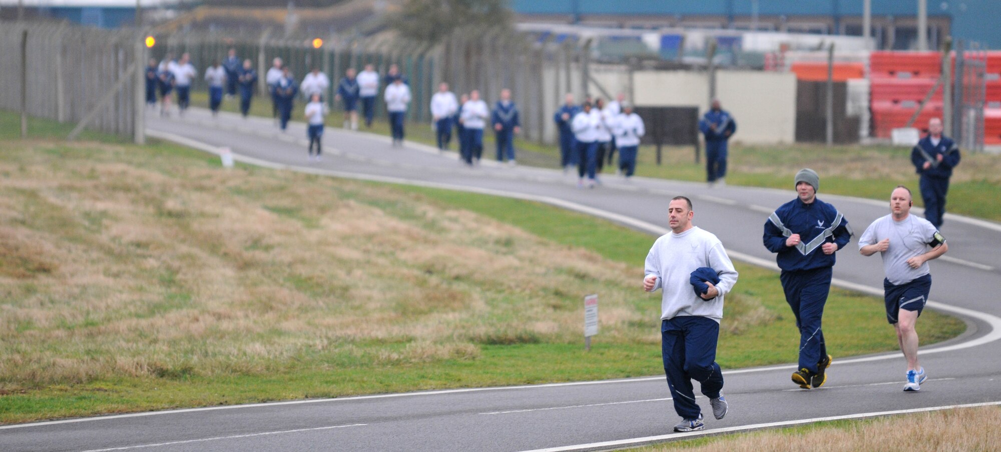 Members of Team Mildenhall power through the wing run Jan. 11, 2013, at RAF Mildenhall, England. The monthly 5K run encourages morale and camaraderie throughout the base through exercise and healthy competition. (U.S. Air Force photo by Staff Sgt. Austin M. May/Released)