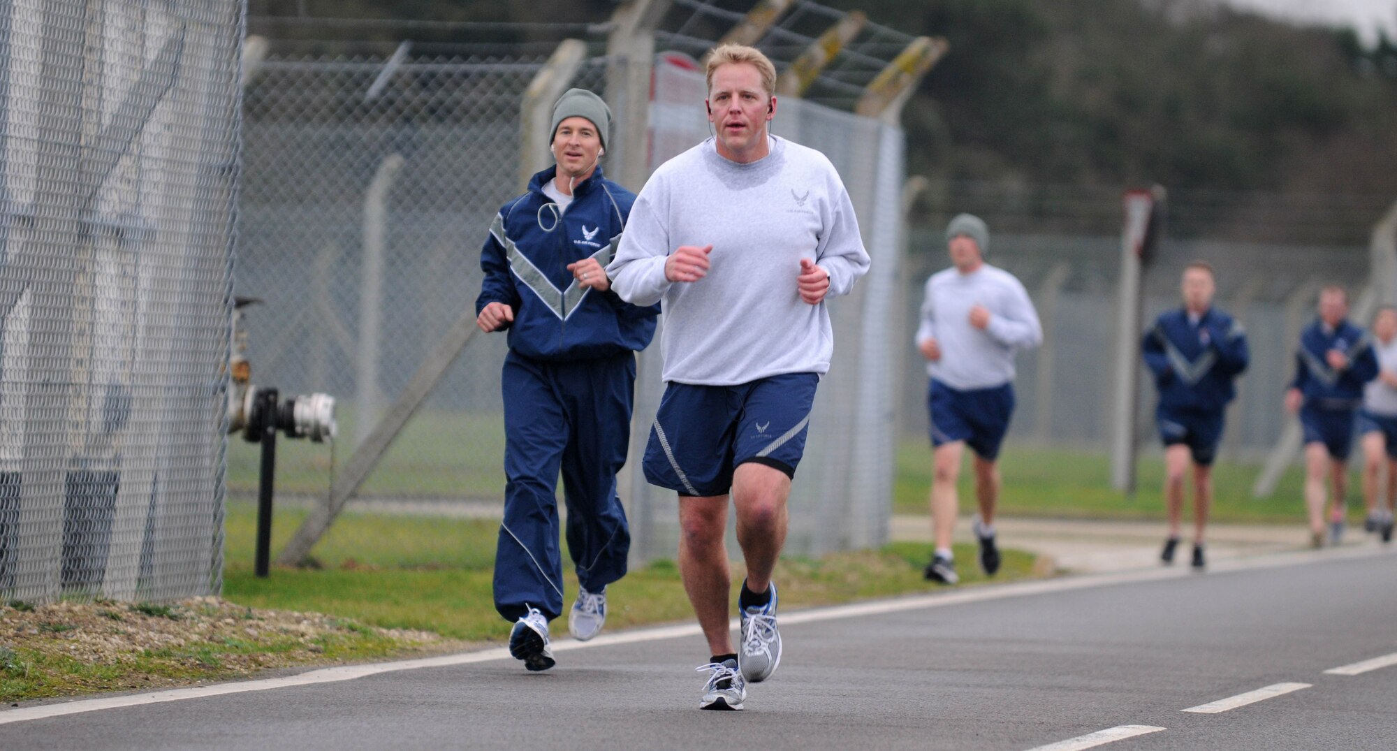 Members of Team Mildenhall approach the final mile of the wing run Jan. 11, 2013, at RAF Mildenhall, England. The monthly 5K run encourages morale and camaraderie throughout the base through exercise and healthy competition. (U.S. Air Force photo by Staff Sgt. Austin M. May/Released)