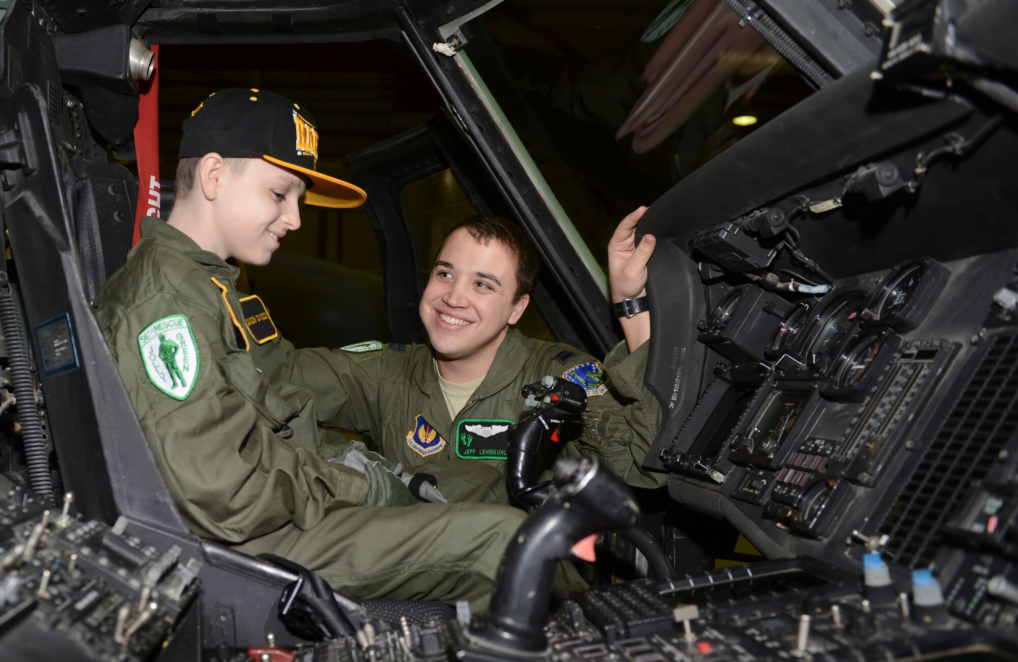 ROYAL AIR FORCE LAKENHEATH, England - Capt. Jeff Lehmkuhl, 56th Rescue Squadron chief of current operations and native of San Bernardino, Calif., shows Dawson Davidson, an 11-year-old Mildenhall resident, around the cockpit of an HH-60G Pave Hawk during a "Pilot for a Day" event Jan. 8, 2013. The "Pilot for a Day" program was started at RAF Lakenheath in March 2012 by Maj. Jason Bianchi, 493rd Fighter Squadron pilot, with the intent to assist children throughout local communities who are fighting life-threatening illnesses or conditions by providing a day of fun and allowing for a break from the routine doctor and hospital visits. (U.S. Air Force photo by Staff Sgt. Stephen Linch)