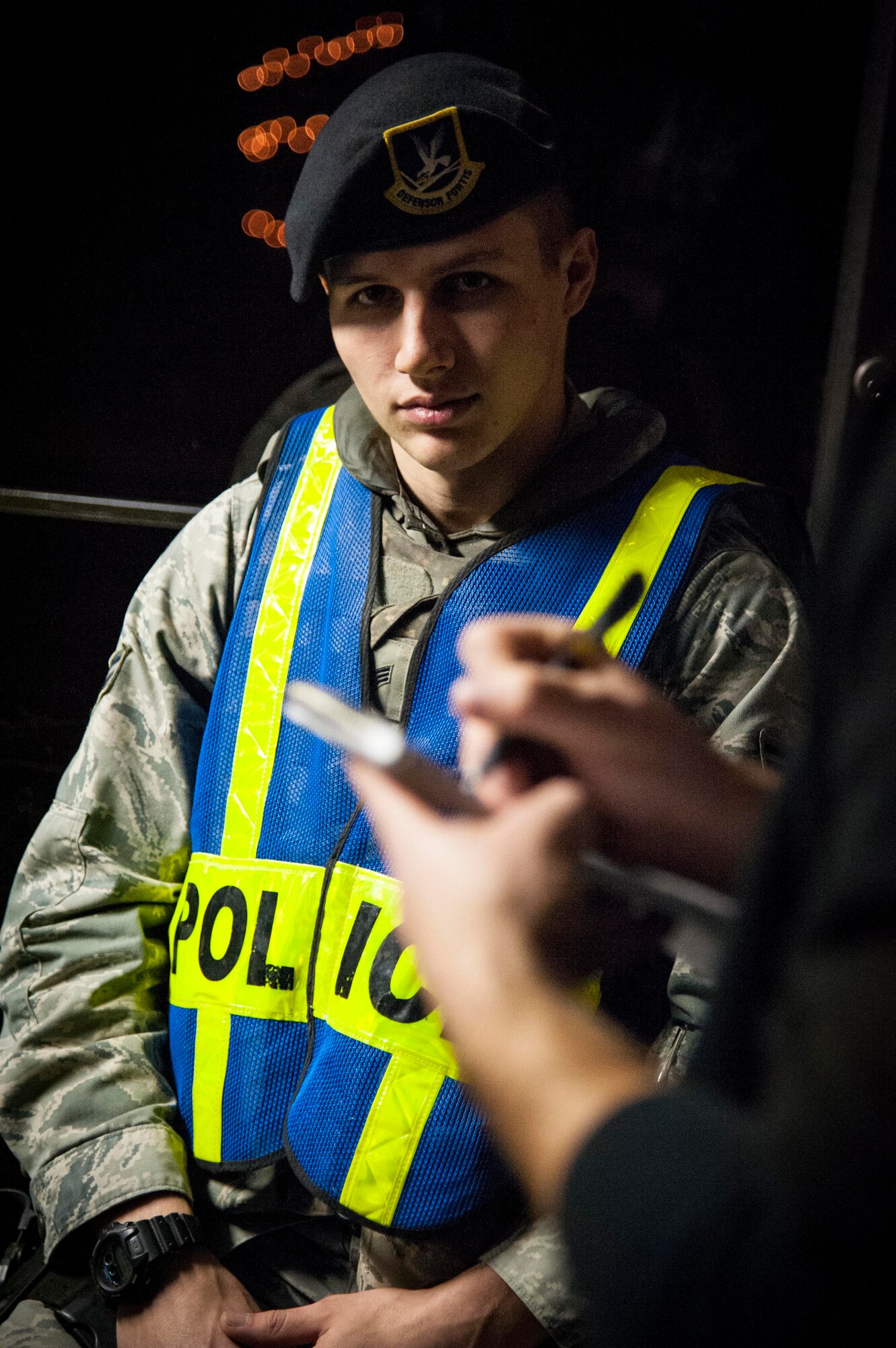 Senior Airman Alexander Hedgecock, 47th Security Forces Squadron patrolman, answers questions from a public affairs member about his duties as a gate guard at the main gate of Laughlin Air Force Base, Texas, Jan. 7, 2013. No matter what weather conditions are prevailing or what holiday it may be, there will always be a gate guard standing ready year round. (U.S. Air Force photo/Airman 1st Class Nathan Maysonet)