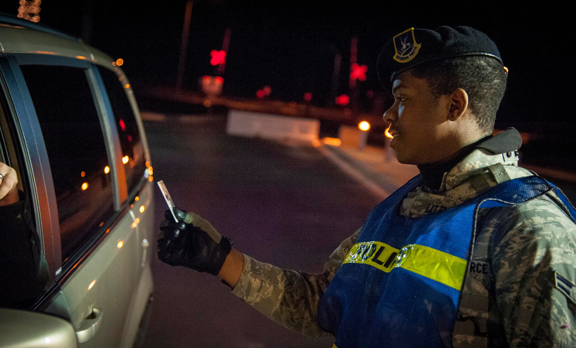 Airman 1st Class James Little, 47th Security Forces Squadron patrolman, checks the ID card of a driver entering the main gate of Laughlin Air Force Base, Texas, Jan. 7, 2013. No matter what weather conditions are prevailing or what holiday it may be, there will always be a gate guard standing ready year round. (U.S. Air Force photo/Airman 1st Class Nathan Maysonet)