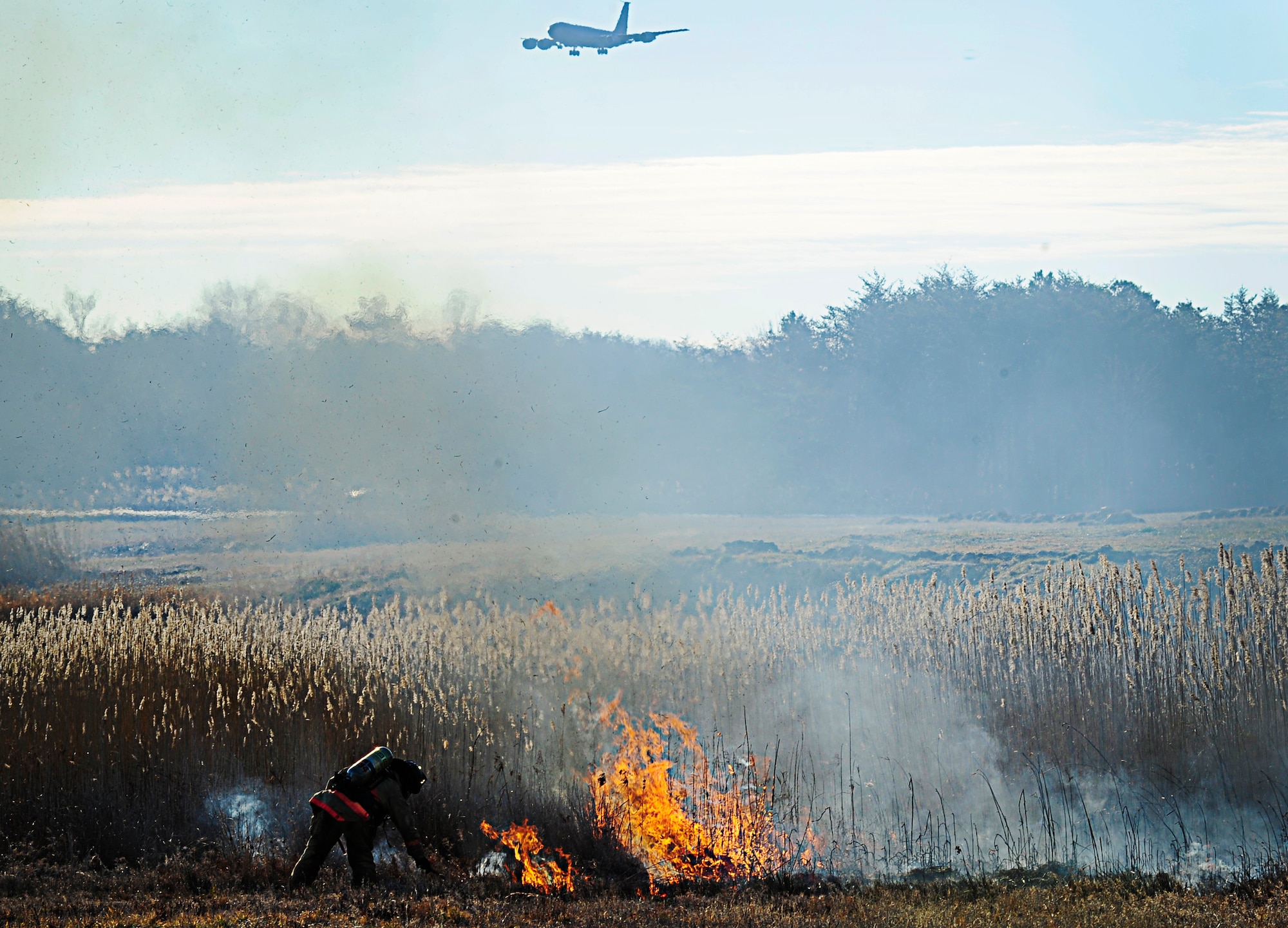 JOINT BASE ANDREWS, Md., - Tech. Sgt. Roger Dupuis, 11th Civil Engineering Squadron assistant chief of training, lights a fire on the flightline here during a controlled burn Jan. 10, 2013 The fire department conducted the burn to decrease the potential for Bird Aircraft Strike Hazards. (U.S. Air Force photo/Senior Airman Lauren Main)