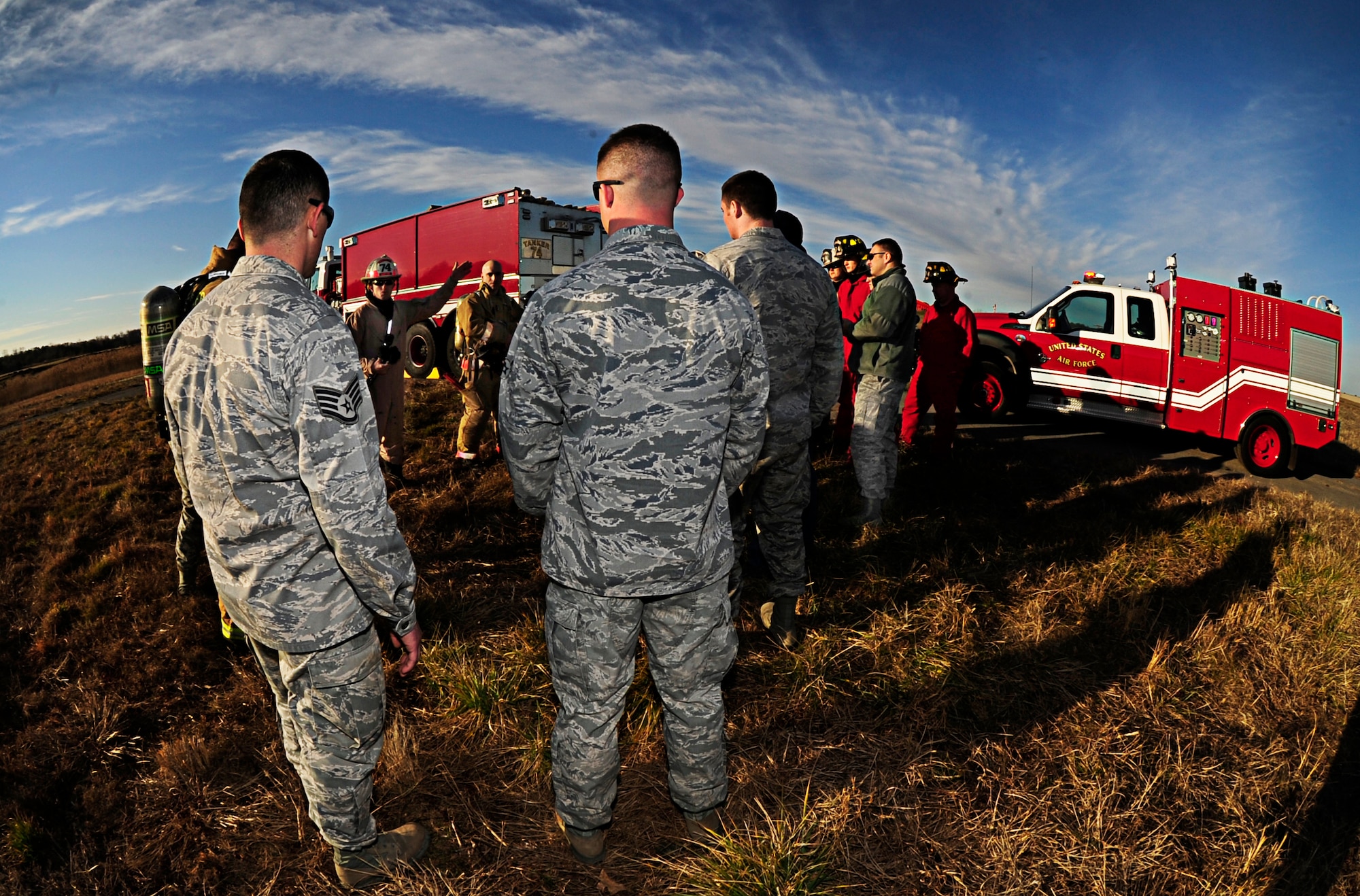 JOINT BASE ANDREWS, Md., - Airmen from the 11th Civil Engineering Squadron listen to a brief about safety procedures prior to the controlled burn on the flightline Jan. 10, 2013. The fire department conducted the burn to decrease the potential for Bird Aircraft Strike Hazards. (U.S. Air Force photo/Senior Airman Lauren Main)
